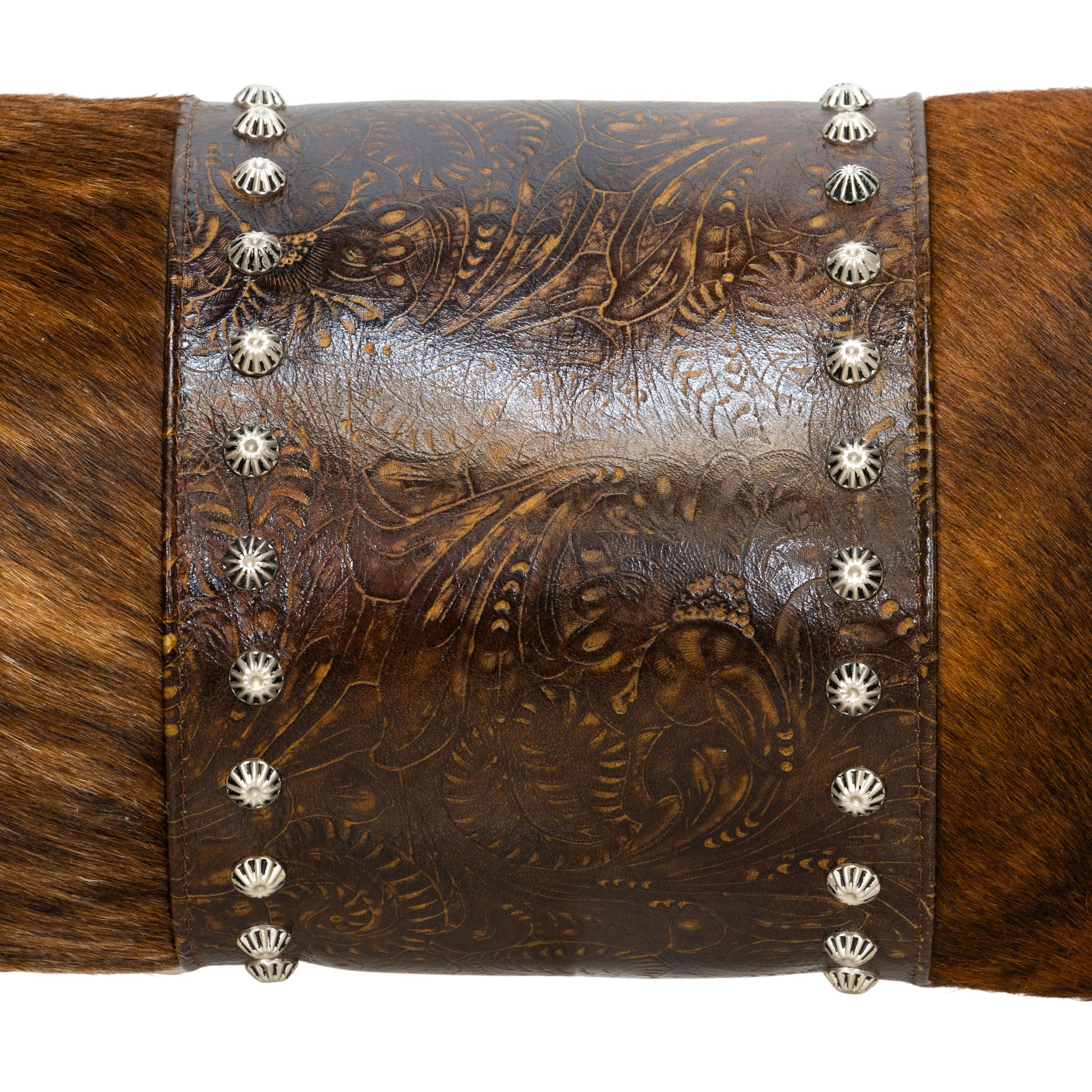 Decorative leather pillow of brindle cowhide with tooled leather and decorative tacks. The unusual brindle coloring blends nicely with the dark leather of the center and the sides. Tacks are only around center leather strip. A functional, yet