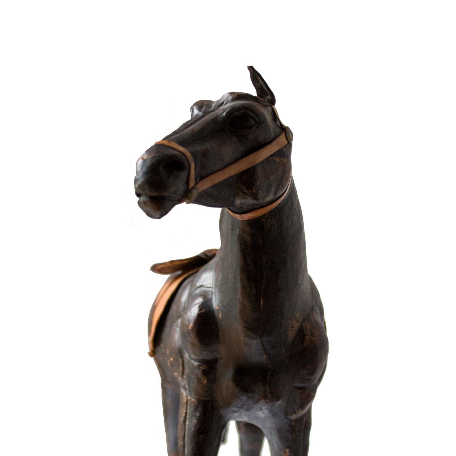 A decorative piece of a leather horse model with saddle from the 1900th century.