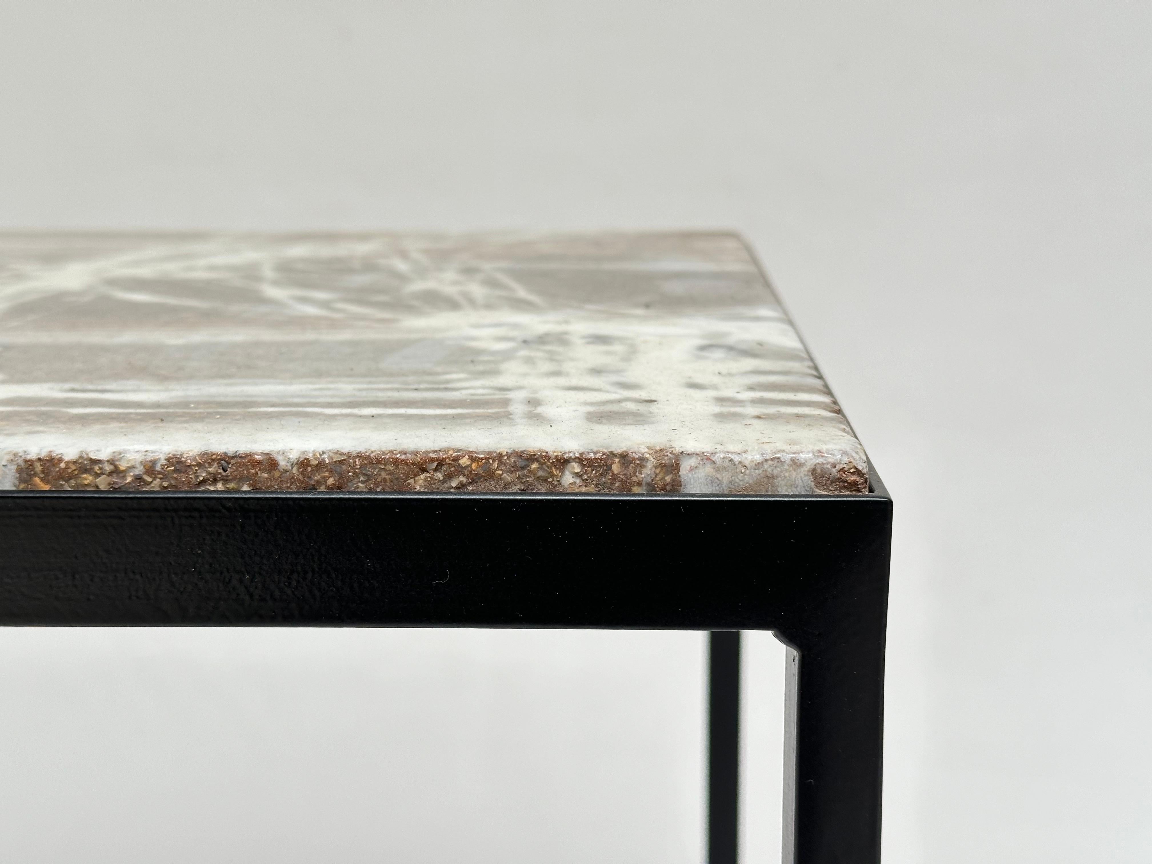 Elegant side table made of a thick slab of glazed concrete with an abstract pattern resting on a lacquered steel base, signed and dated.

 About the Artist 

Jo Amado (b. 1917 - d. 1963) is one of the more prominent ceramists of the Aix en Provence