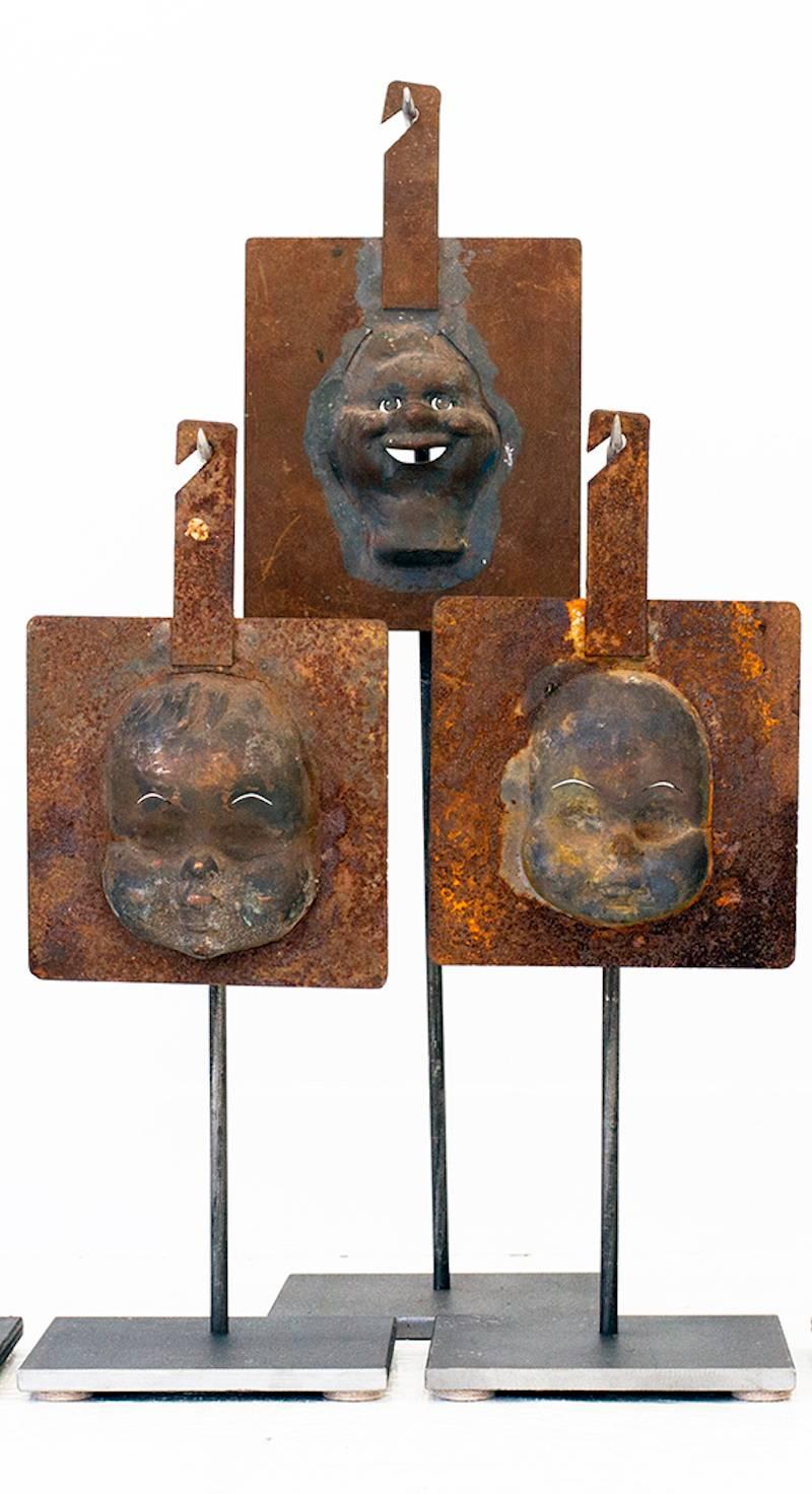 Collection of seven 1940s (six) doll head injection mold metal plates, including one (1) Howdy Doody collector's piece injection mold metal plate. A graphic table, bookcase or center table accessory with nice patina and custom handmade steel stands.