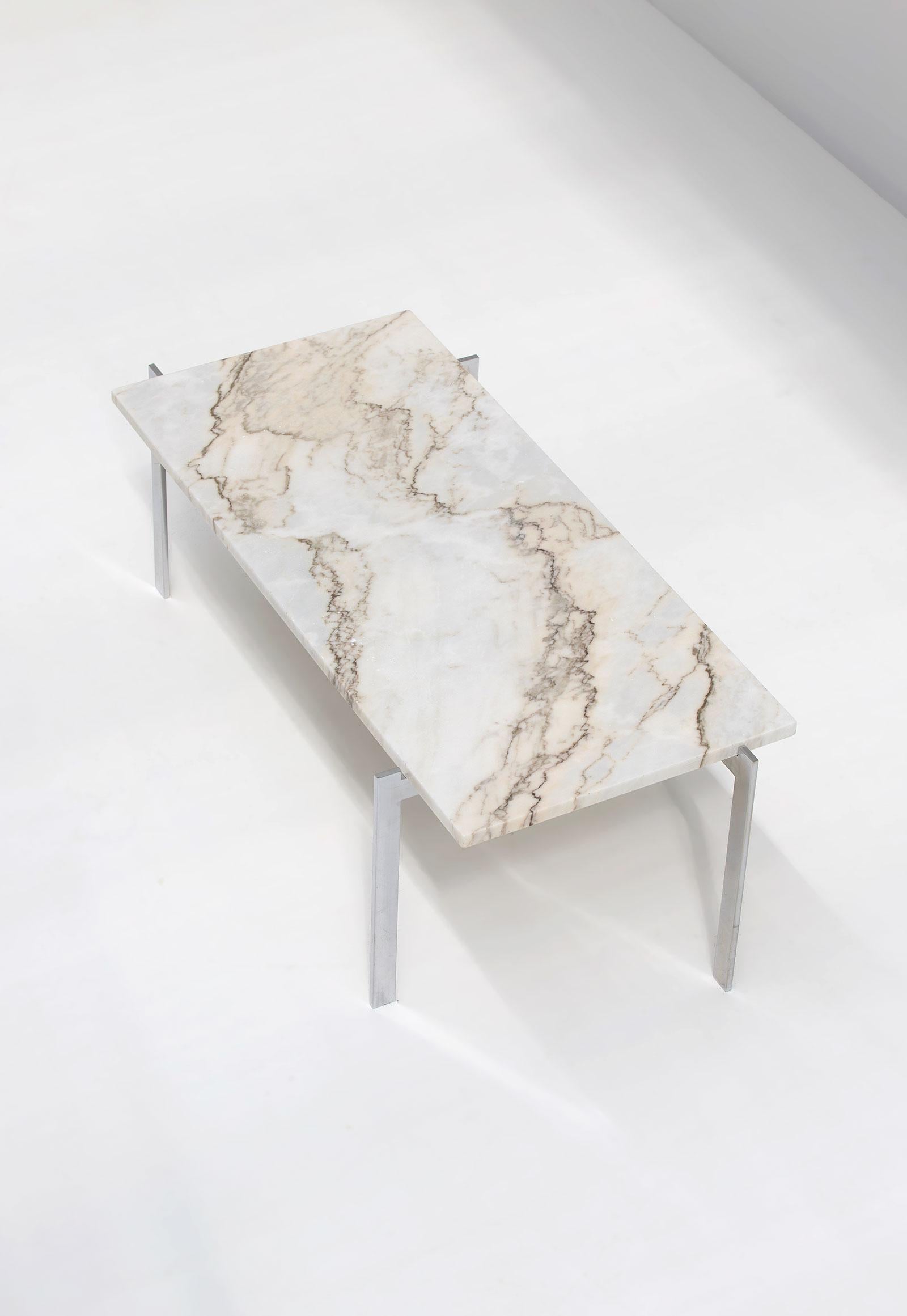 Decorative coffee table in the manner of Poul Kjaerholm, dating from the 70s. This coffee table has a chrome steel base and a white marble table top. Stands in a very good condition.
     