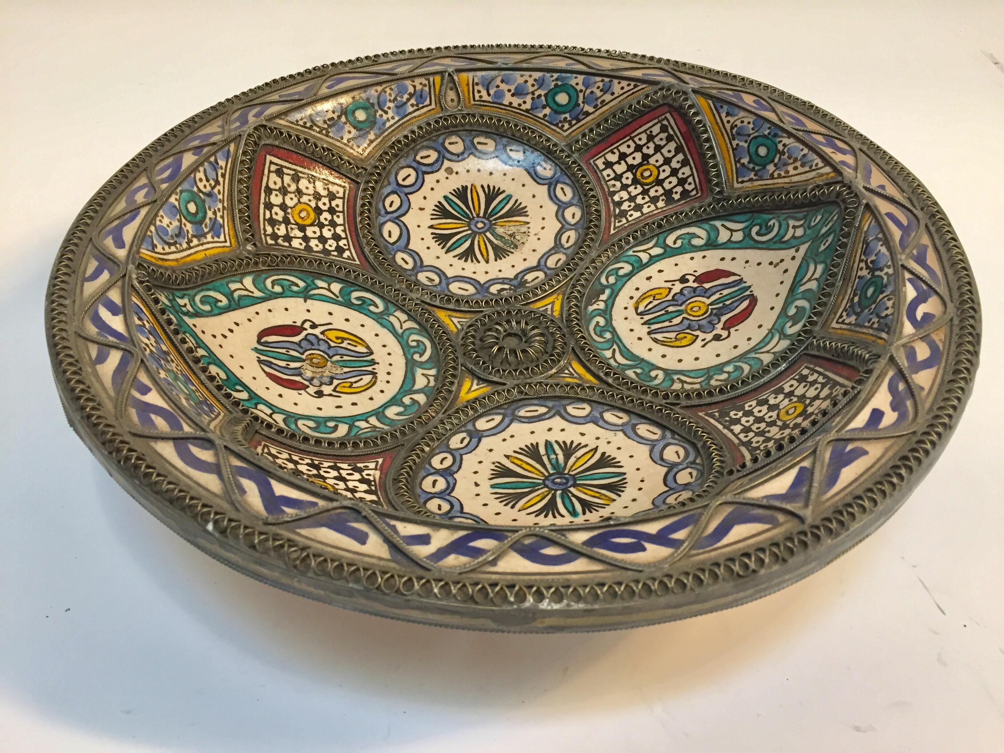 Handcrafted large Moroccan polychrome decorative ceramic plate from Fez. Bleu de Fez, very nice designs hand painted by artist in Fez.
Antique ceramic handcrafted bowl with geometrical and floral designs in blue and white and polychrome adorned