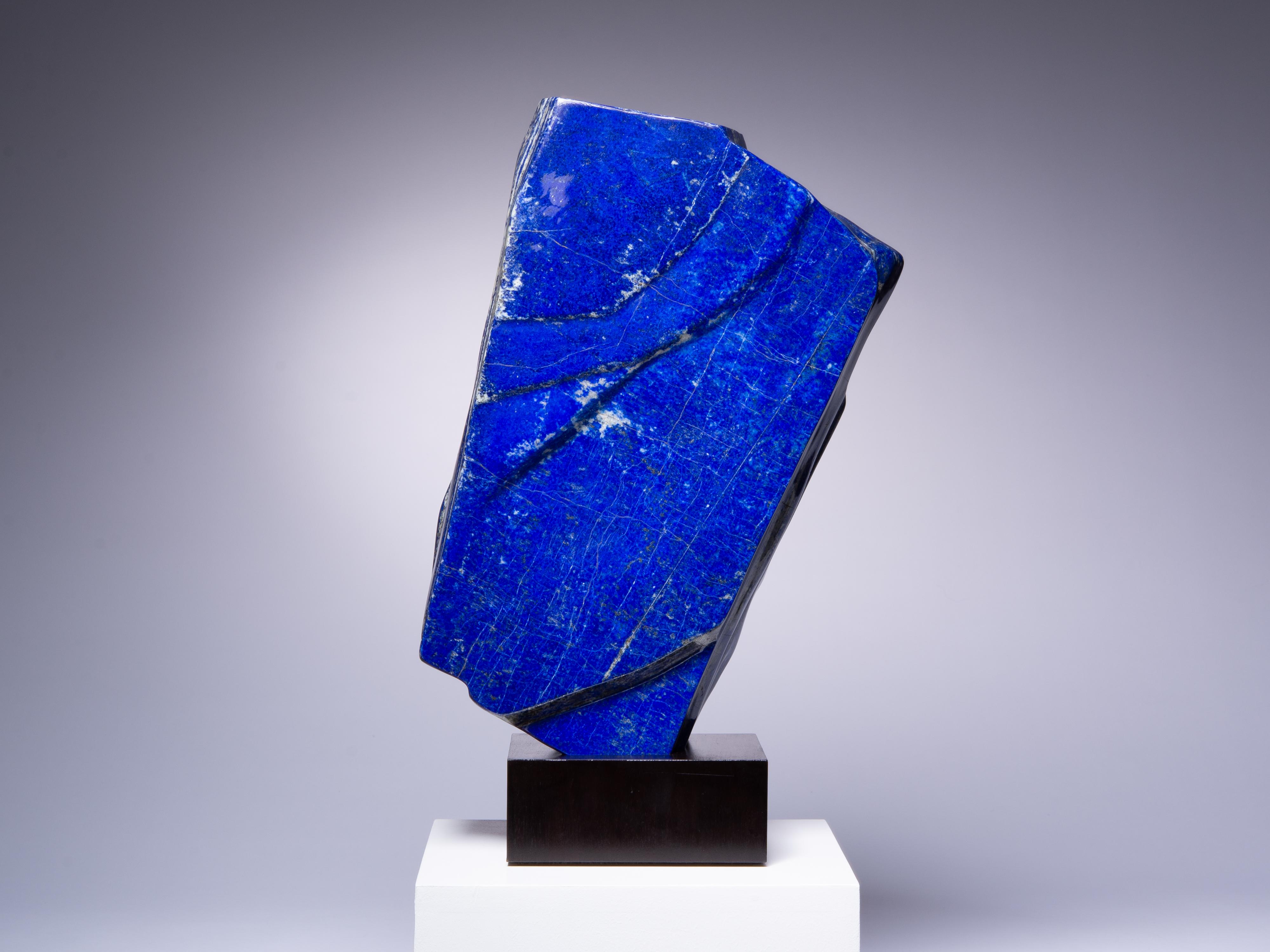 A gorgeous slab of vibrant lapis lazuli. Lapis lazuli inclides lazurite (intense
blue), calcite (white veins) and pyrite (gold flecks). Prized since ancient
times, this is a wonderful example.

This piece was legally and ethically
