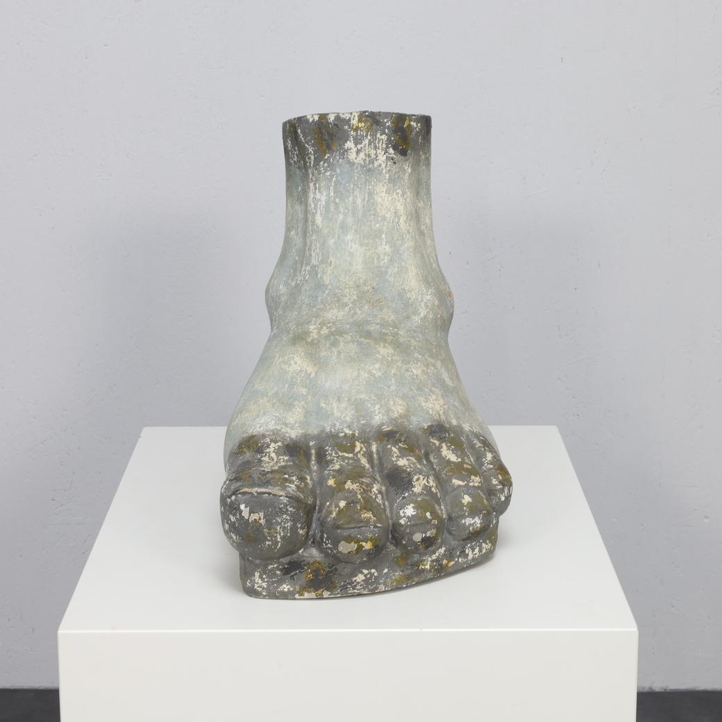 This striking sculpture of a human foot was created in the 1960s by an unknown artist. Measuring 42 x 61 x 28 cm, it commands attention with its monumental form and rich surface character.

Over time, the piece has developed a beautiful patina. Its
