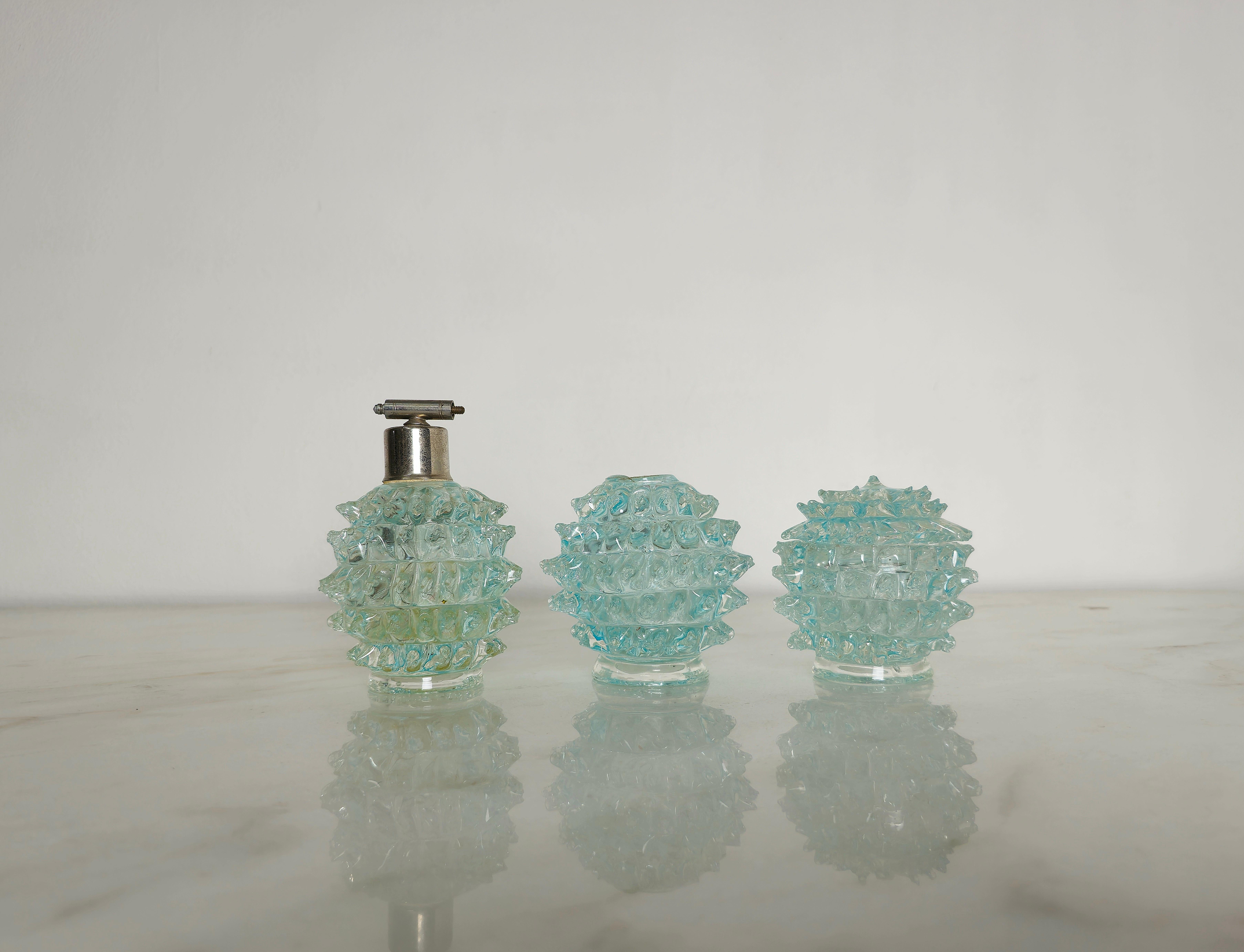 Set of 3 toiletries made in the 1940s by Barovier&Toso in rostrated Murano glass in shades of transparent and light blue.
We would like to point out that this set is sold only as a decorative or display object as it has lost its original