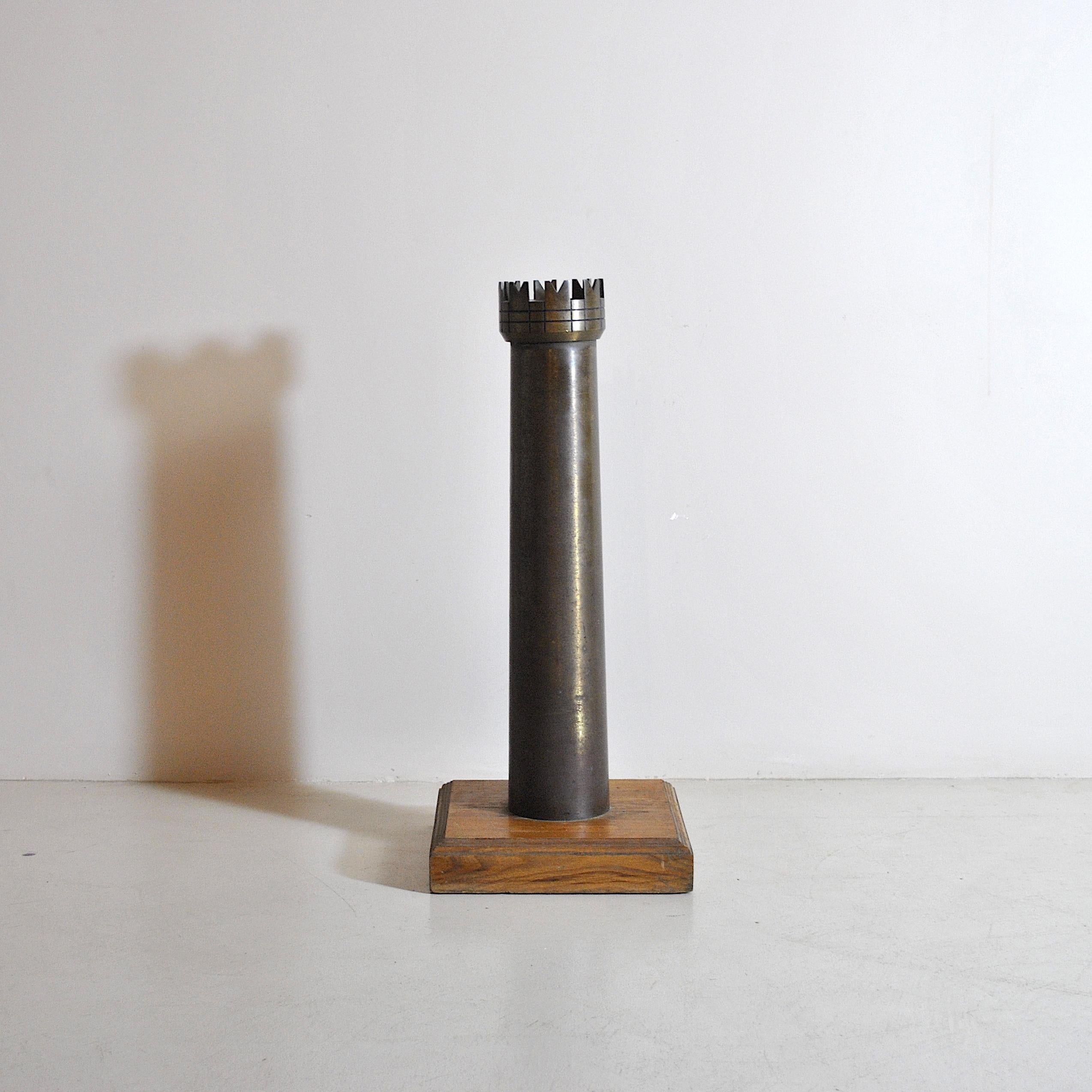 Original decorative object depicting an element of the game of chess, the rook, 1960s production in bronze with wooden base.