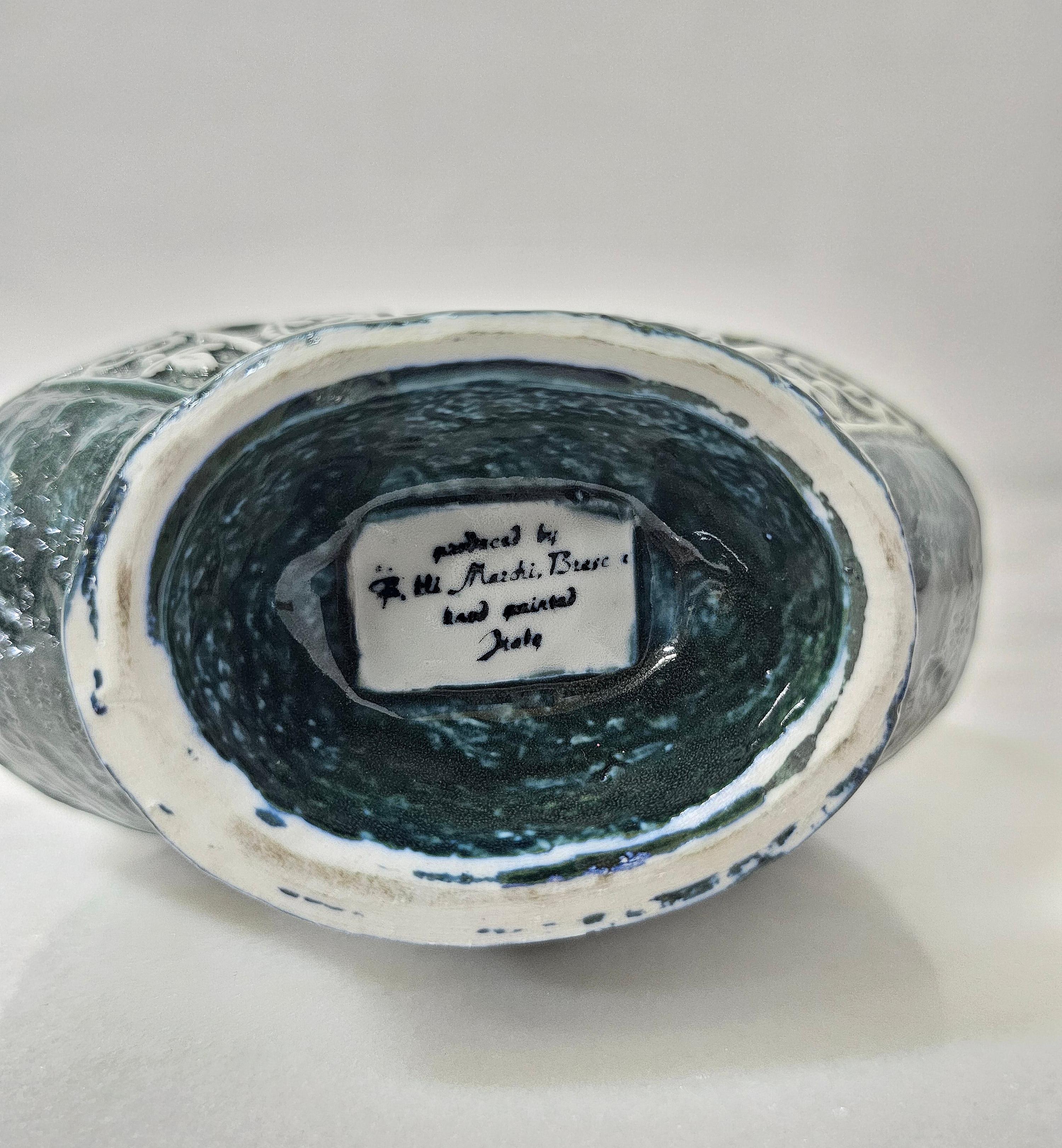 Vase with handles made of enamelled ceramic in the shade of dark green with abstract and animal decorations in the shade of white.
Fratelli Marchi Brescia, Italy 1950'/1960'.


Note: We try to offer our customers an excellent service even in