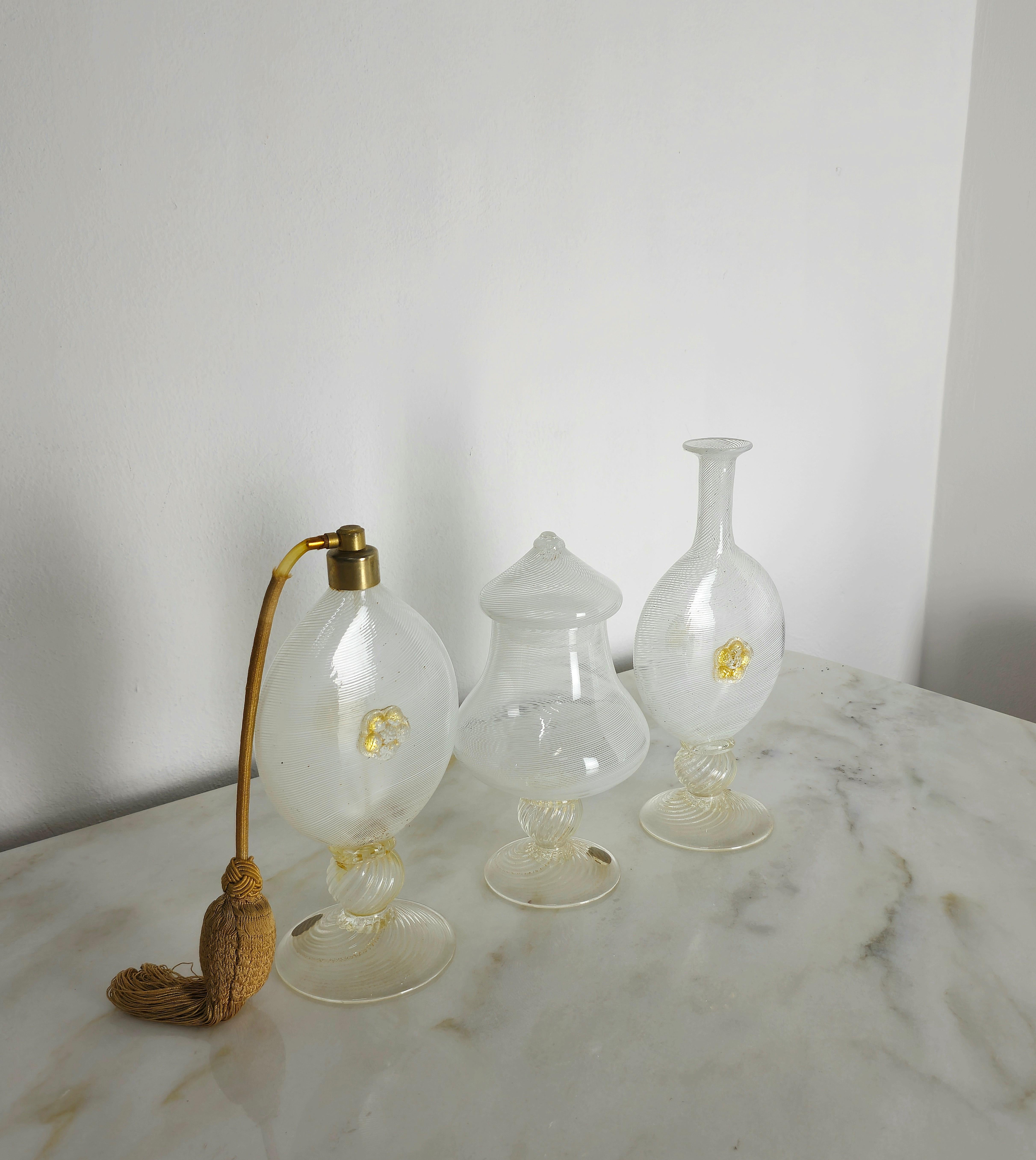 Set of 3 bathroom/toiletry objects made in the 1940s by Barovier&Toso in Murano glass with white filigree in shades of transparent and white with golden decoration.
We would like to point out that this set is sold only as a decorative or display
