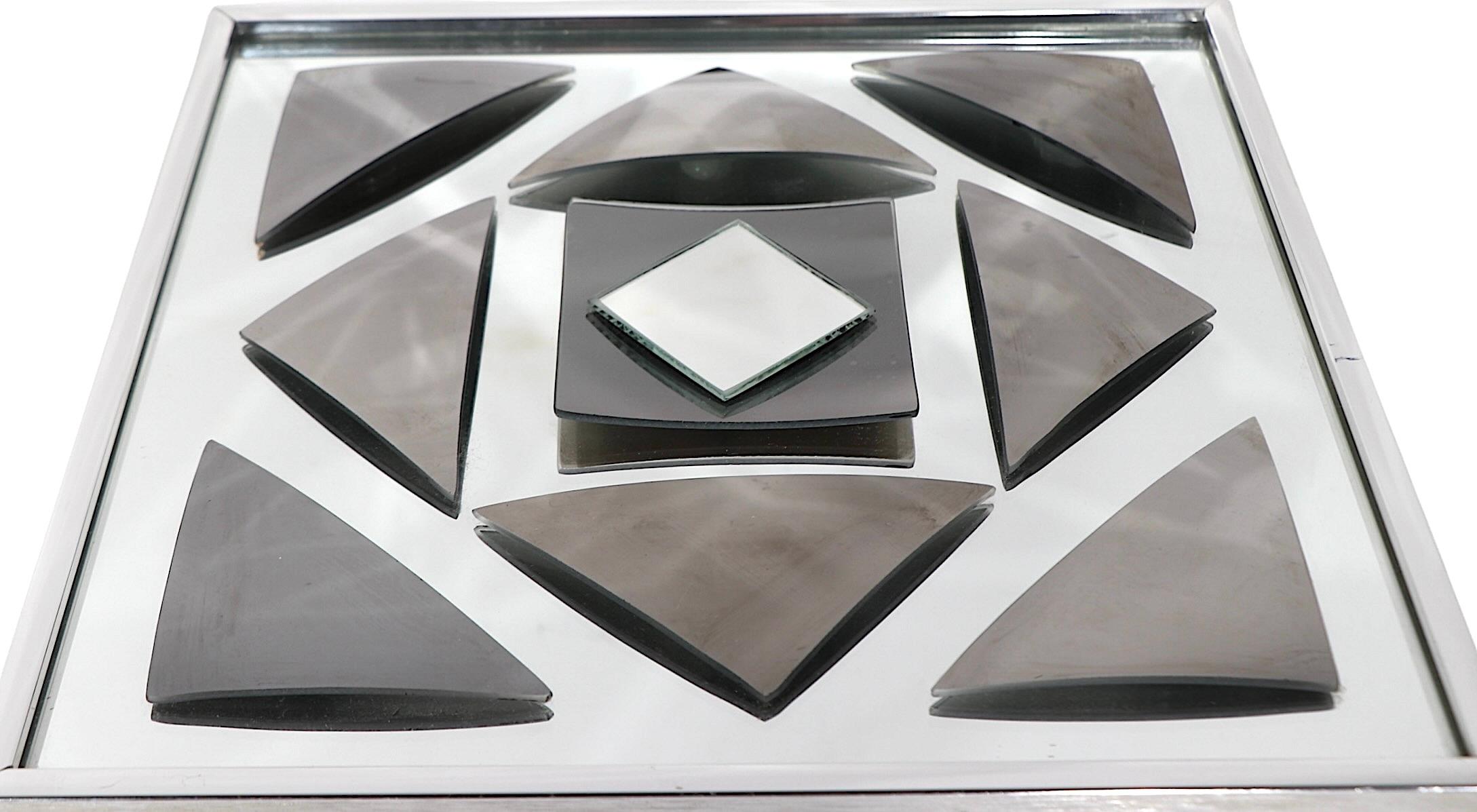 Exceptional decorative, Post Modern, Op Art style wall mirror by noted glass/mirror artist Hal Bienenfeld, circa 1970's. The mirror features a silvered mirror ground, with tinted bowed triangular and square decorative elements, with  a silvered