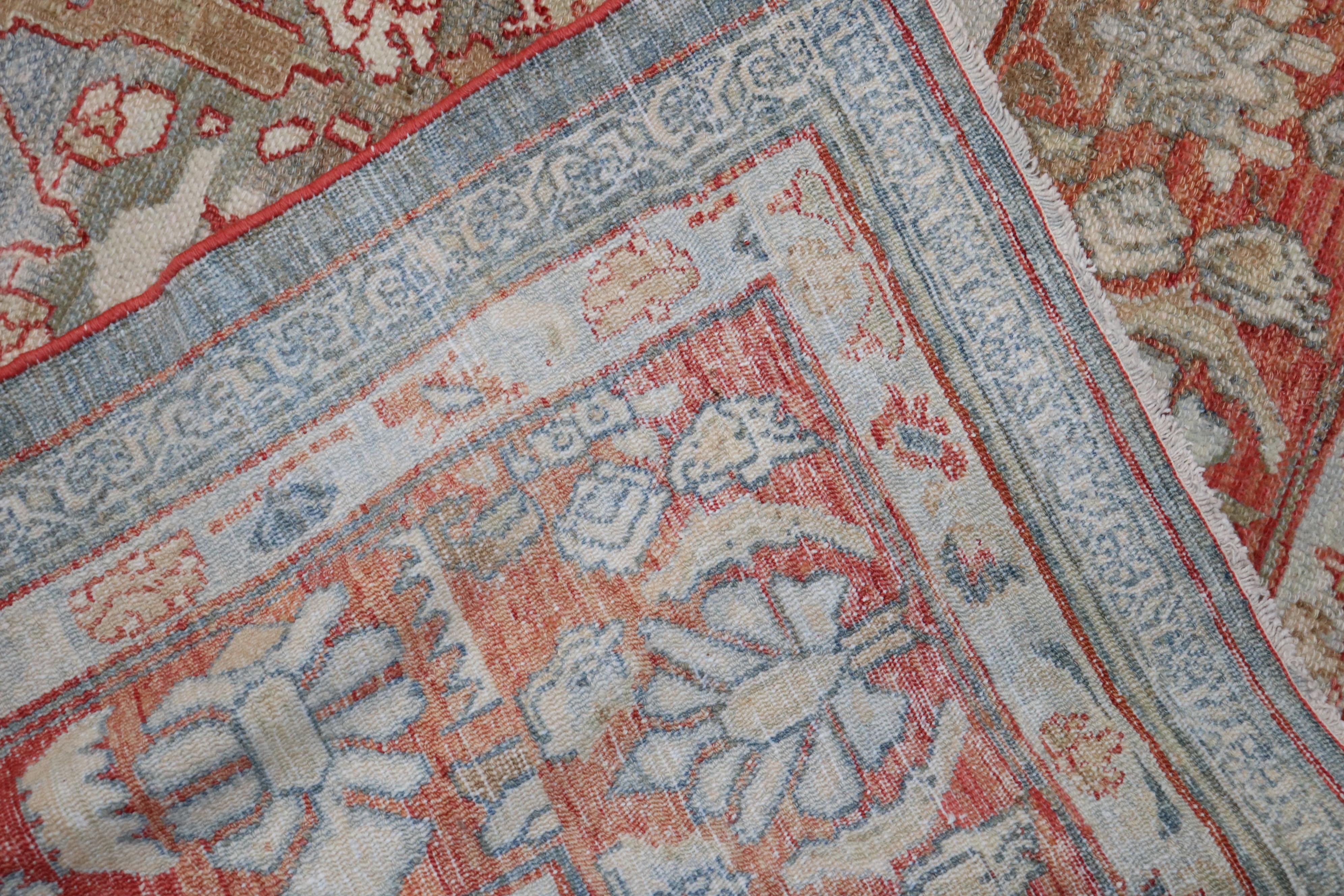 An early 20th century Persian Bibikabad rug with a striking gray blue field and soft red border. Accents in brown, silver and ivory.

Measures: 10'7