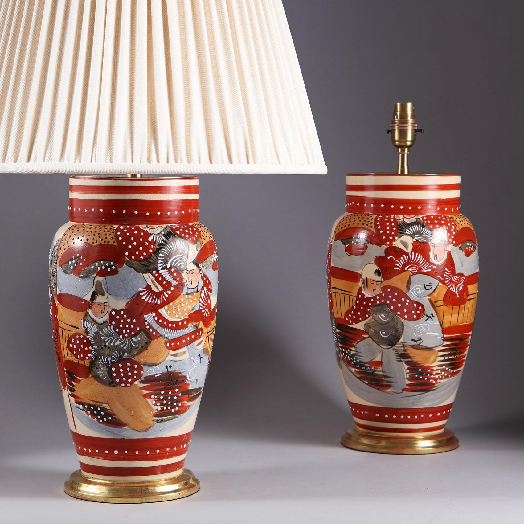 Decorative pair of Japanese 20th century vases mounted as table lamps, decorated with martial arts scenes painted in broad brushstrokes of reds, oranges and blues and picked out with raised white details, Now mounted as table lamps.
The vases,