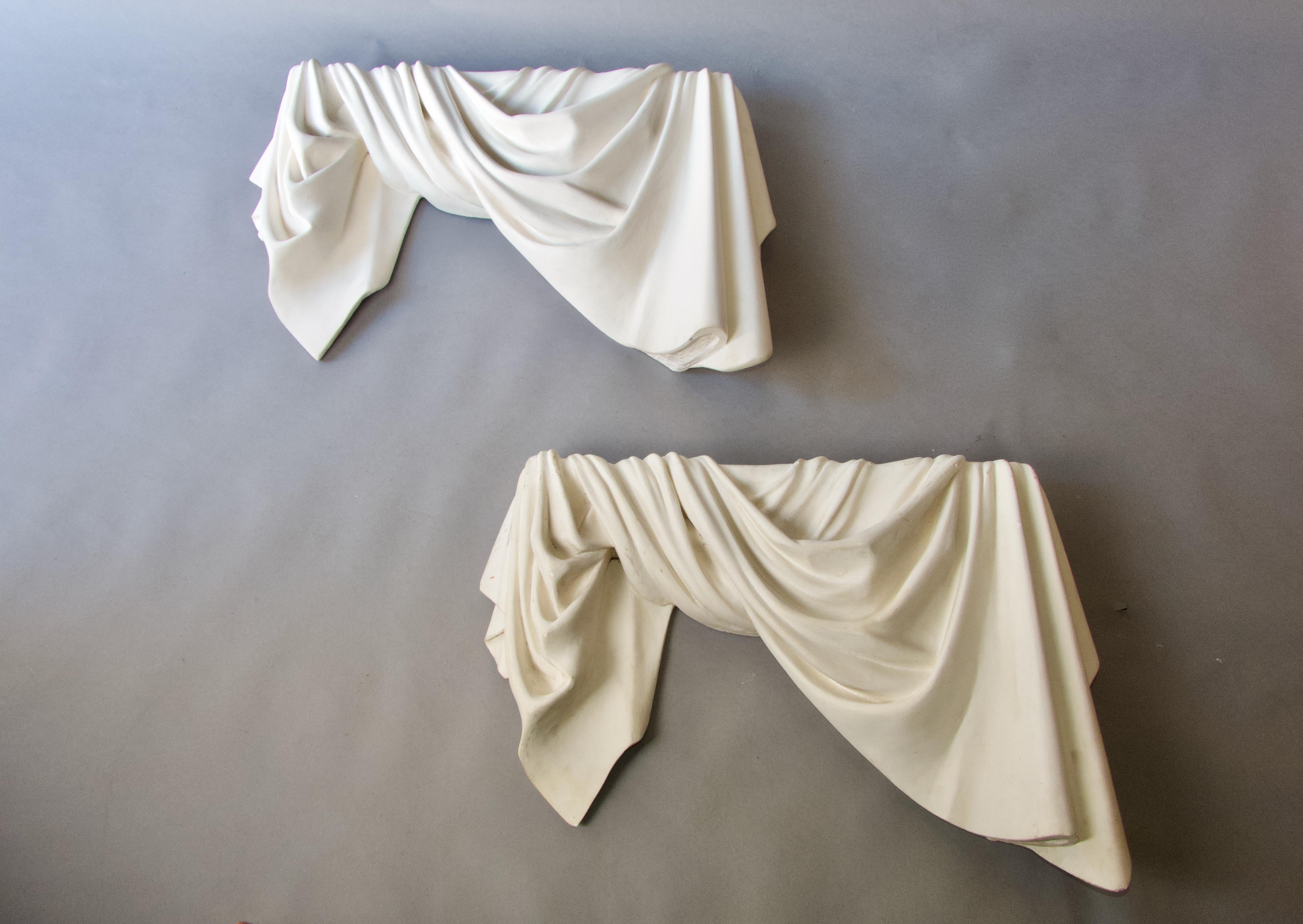 Pair of sculpted plaster drapes from the 1940s. One of the two is in less good condition, some missing plaster on the surface for example, but very easily restorable. The pair can easily be transformed into a light wall lamp, which would be very