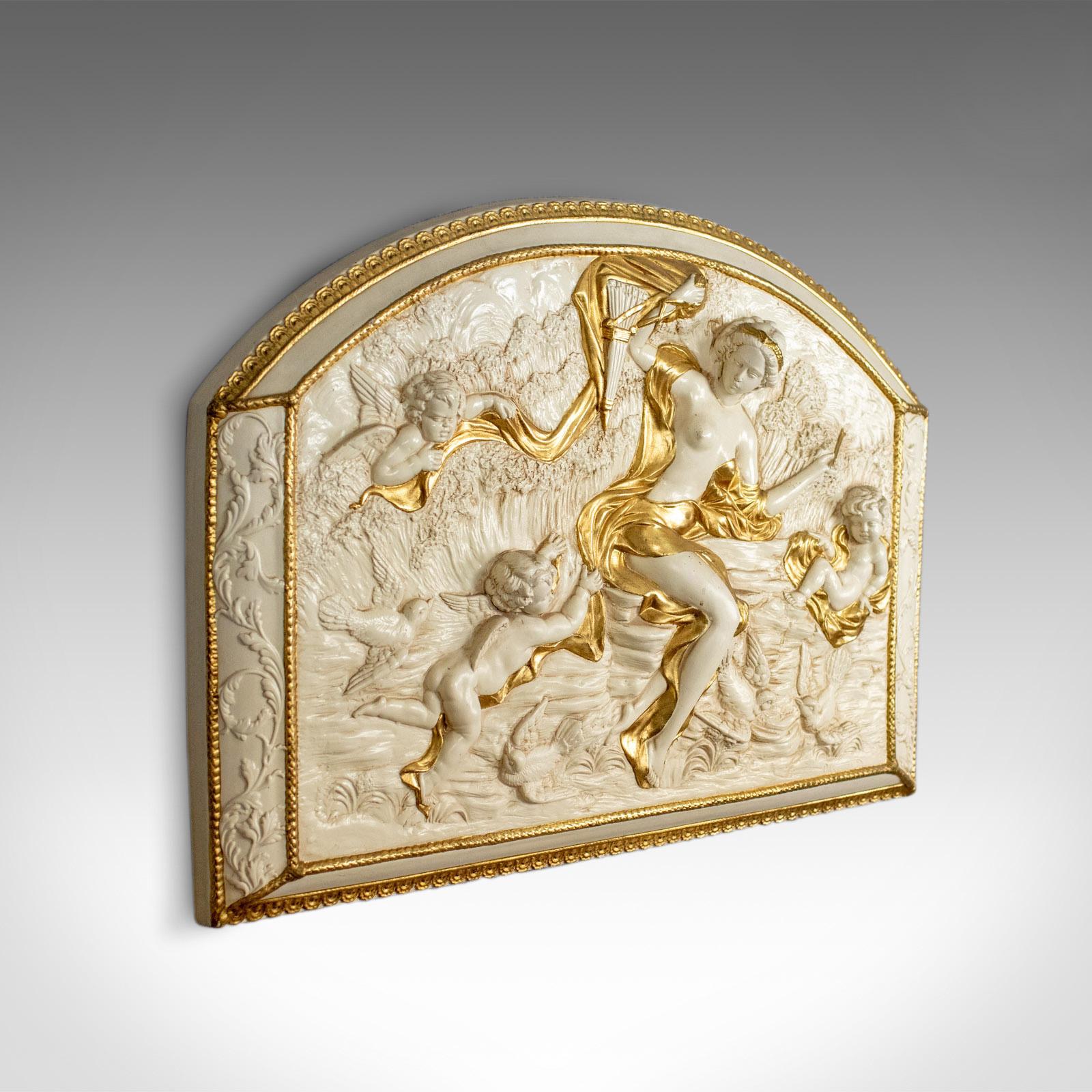 This is a decorative panel, a plaster relief of a female with putti highlighted in gold. A plaque dating to the late 20th century.

Beautifully detailed plaster panel
Profusely decorated and highlighted in gold
Classical scene of a female