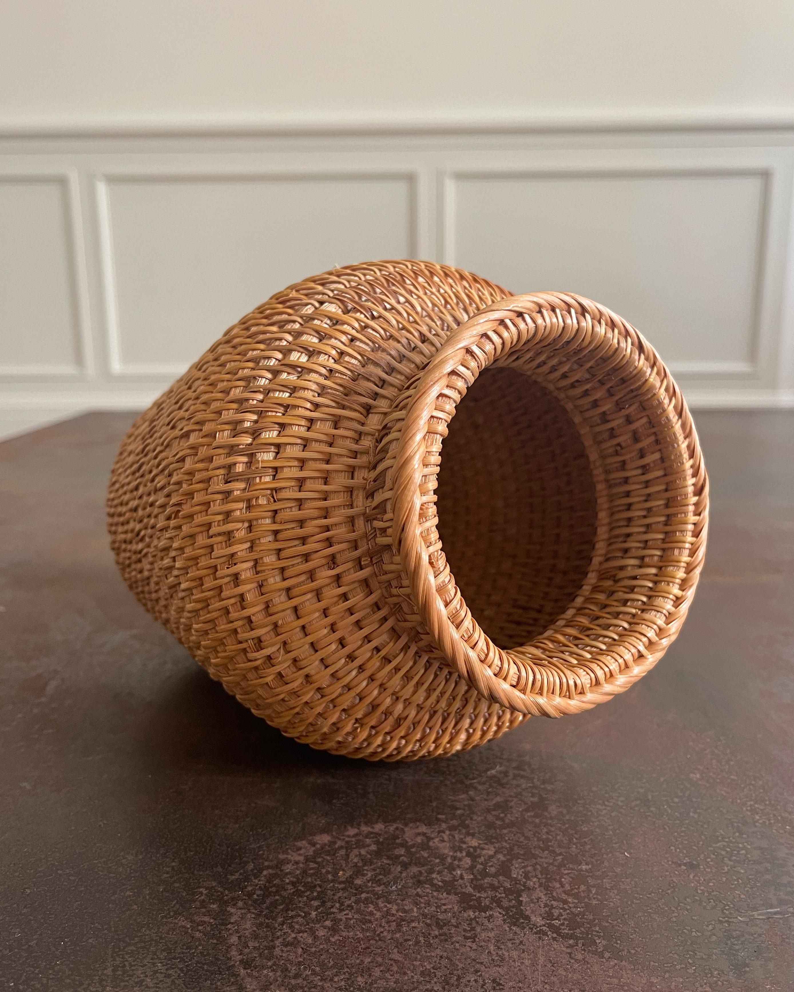 Eine klassische handgeflochtene dekorative Vase aus Rattan. Unbeschichtete Oberfläche. Nur für Kunstblumen oder Trockenblumen geeignet.

Abmessungen:
- 3,25