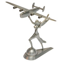 Used Decorative Sculpture of a Goddess Holding a Consolidated B-24 Liberator