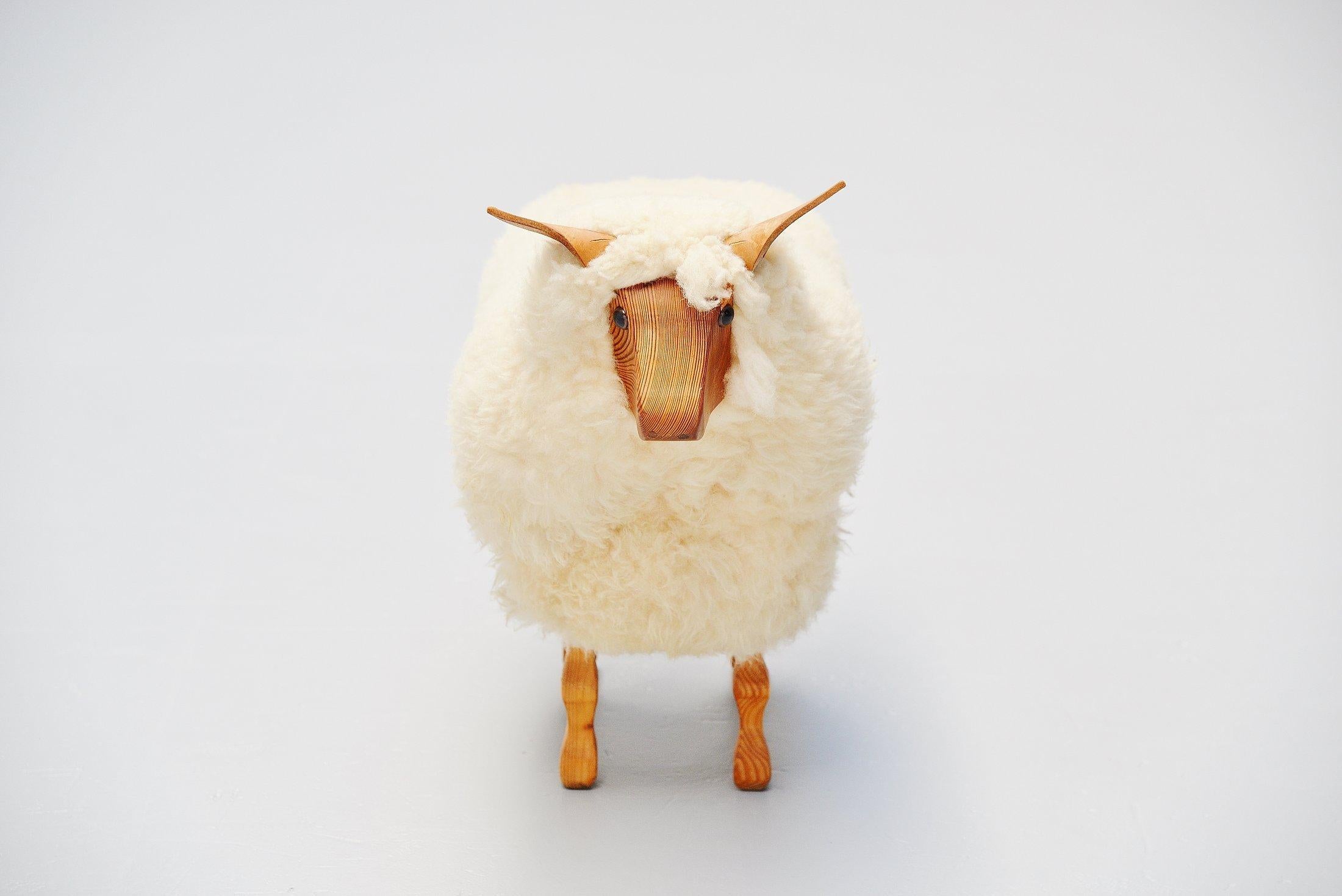 Very nice decorative sheep made by unknown manufacturer Holland, 1970. This sheep was made of solid pine wood and is covered with real sheep wool, its ears are made of leather. These sheep were designed as shop window decoration for blankets made of
