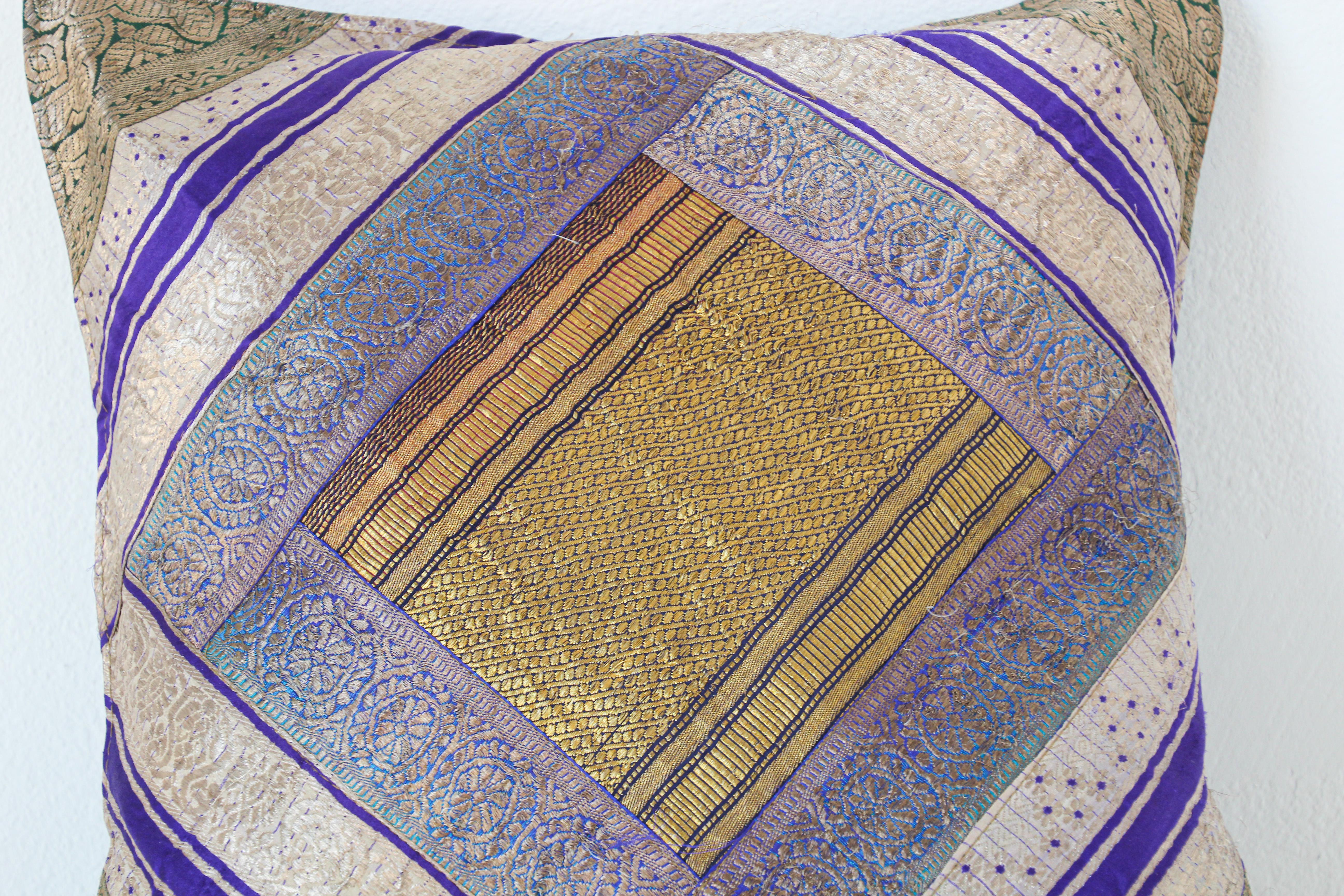 Decorative accent throw pillow made from vintage sari borders.
One of a kind, blue, green, gold, green, purple, metallic threads.
Handcrafted in India.

   