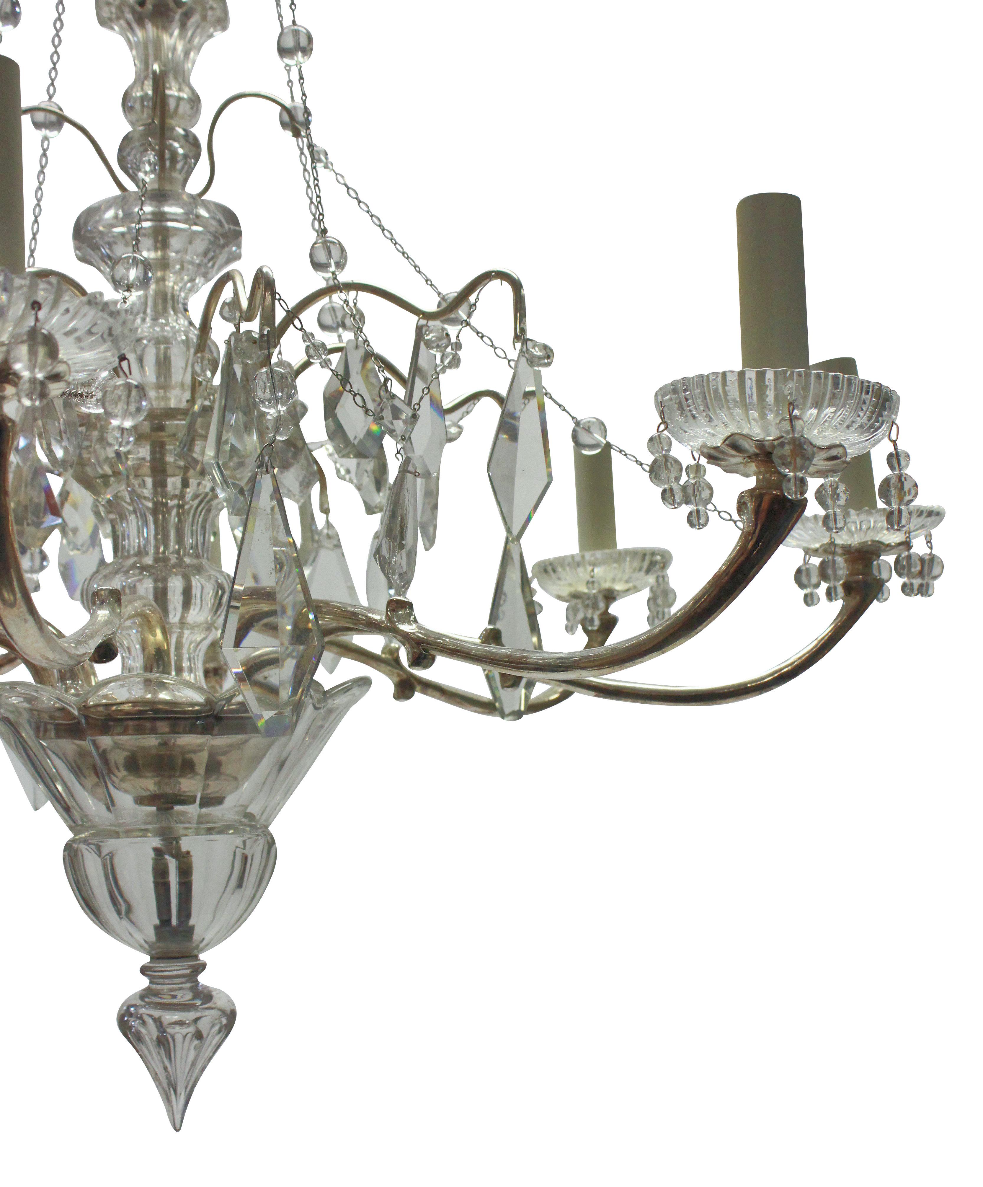 A decorative French silver plated and cut glass chandelier of six arms. Hung throughout with finely cut plaques, chains & beads, with a crisply cut central baluster stem and finial.