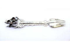 Decorative silver fork with cutouts, caravel and angels around monogram