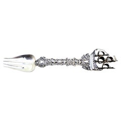 Decorative silver fork with cutouts, caravel and angels around monogram