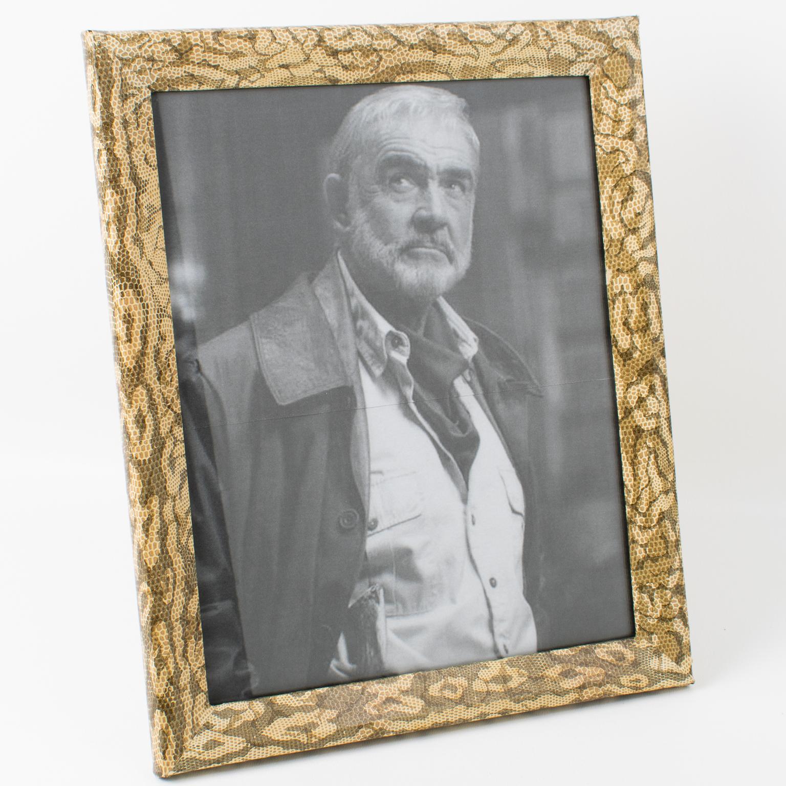This lovely decorative picture frame was crafted in France in the 1960s. The frame wooden structure is wrapped around with a decorative pattern paper with a snake-skin texture and camouflage flair. The same textured paper is also used on the easel