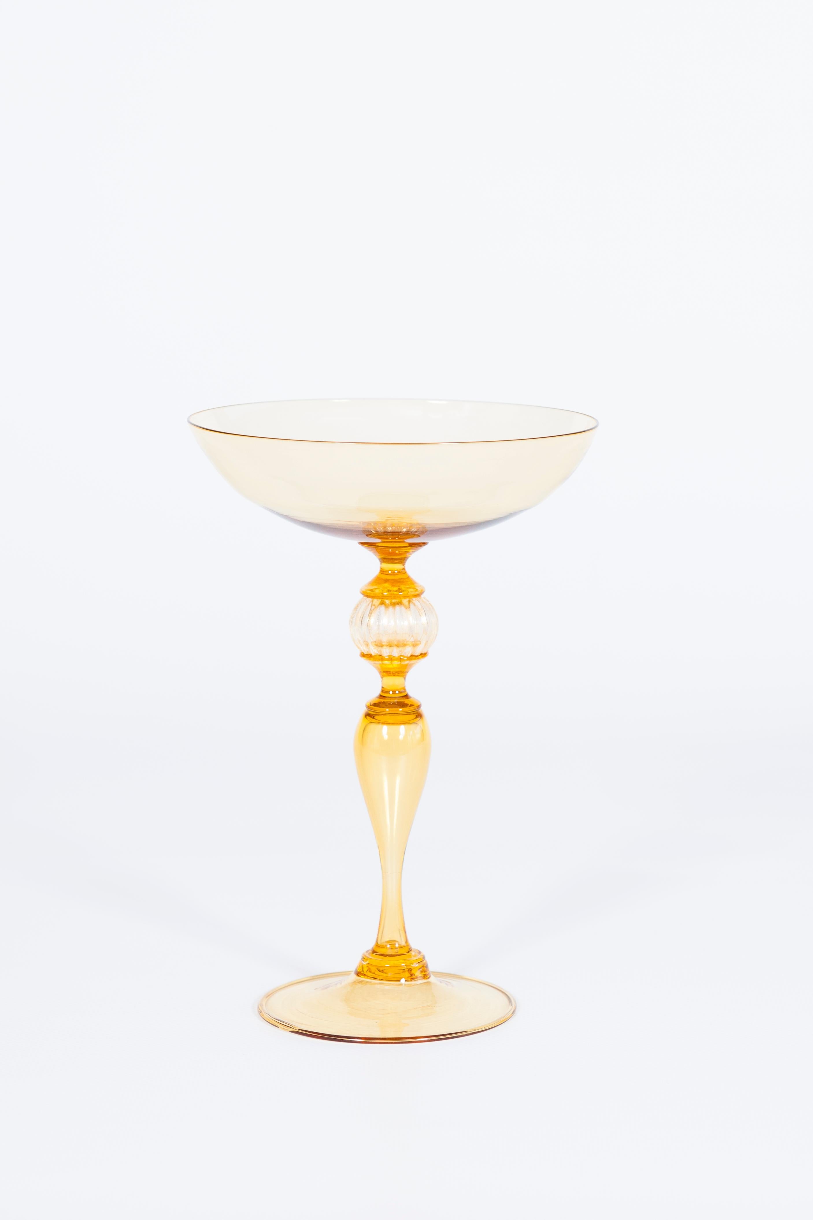 Decorative Stem Glass in Amber Murano Glass with Gold Leaf Italy Venice 1970s.
Entirely handcrafted of blown glass and gold leaf in the 1970s, this elegant stem glass comes from Murano, the Venetian island dedicated to the production of blown glass