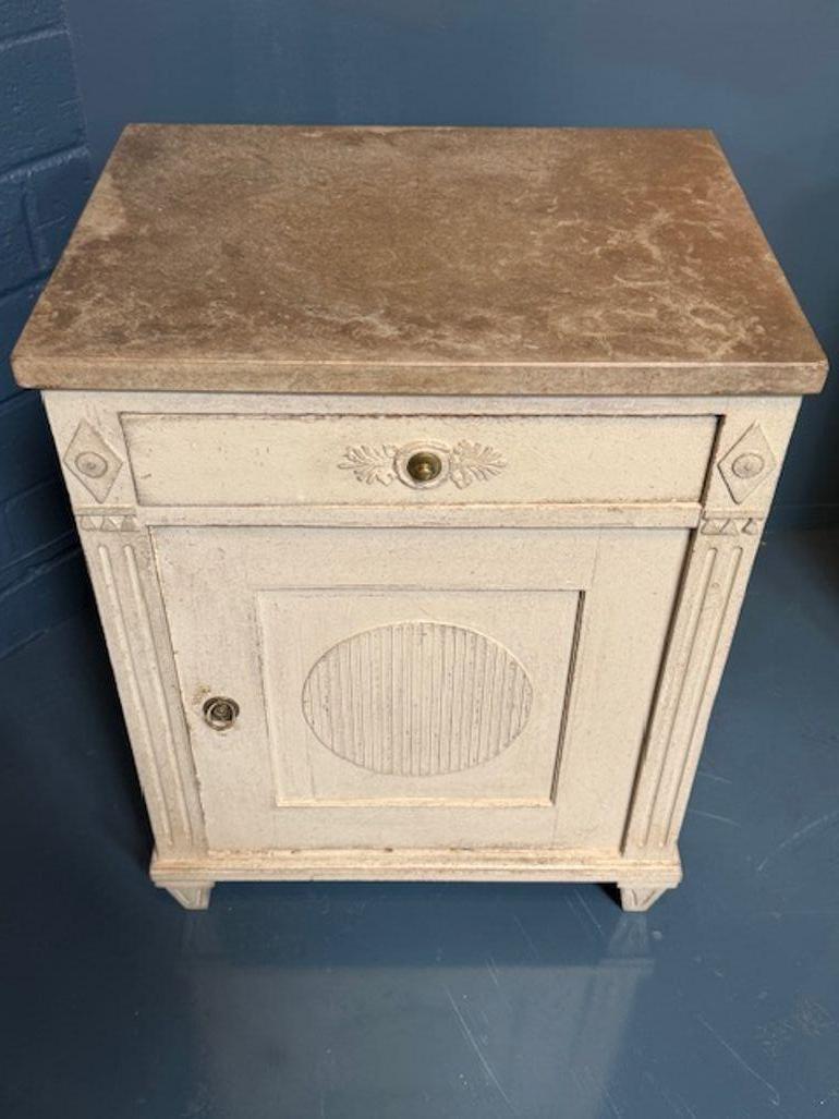 Elevate your home with the elegance of the Swedish Gustavian style. This decorative cabinet features pretty carvings and a meticulously crafted design that brings a touch of sophistication to any room. The cabinet's detailed workmanship showcases