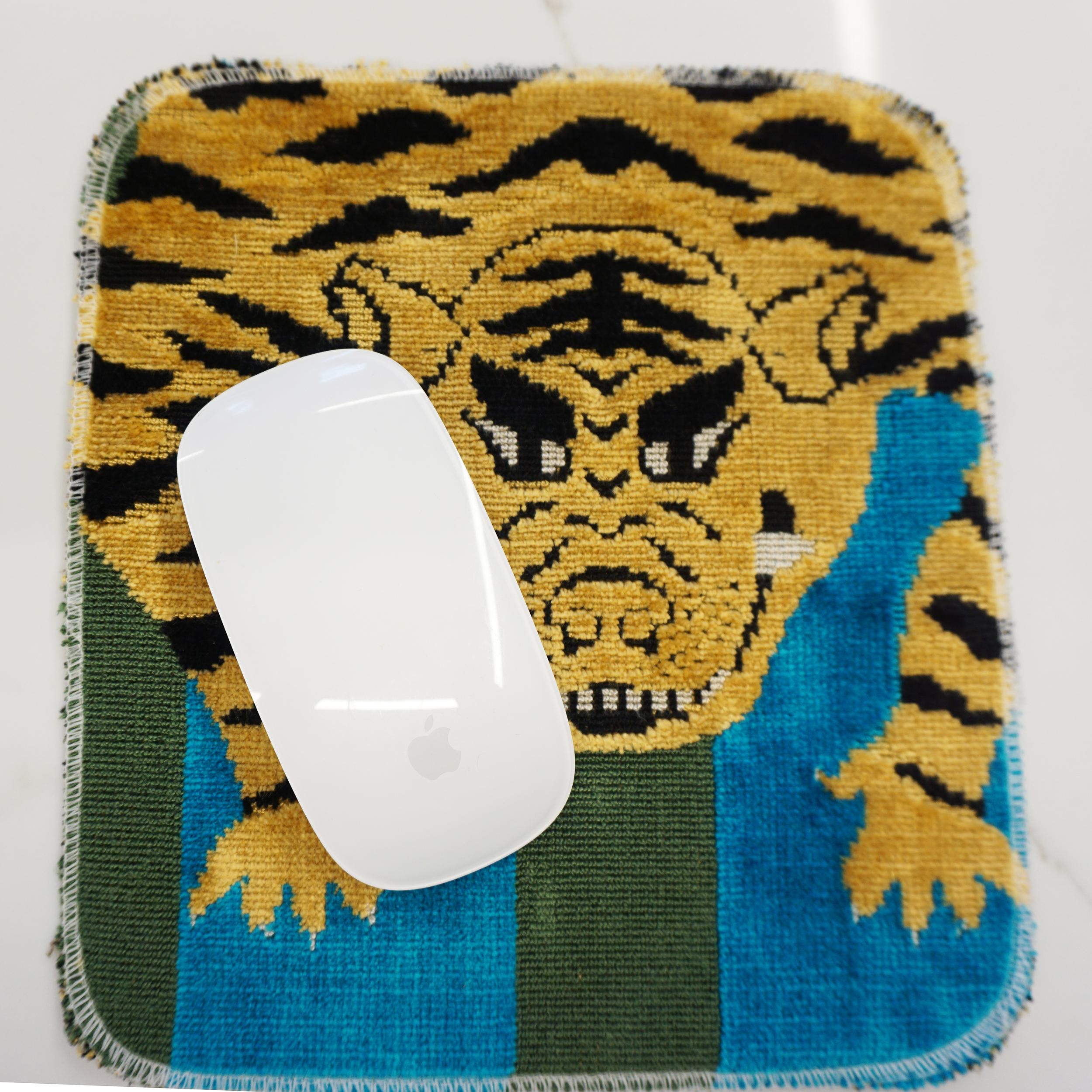 This bold and eclectic mat is made with Schumacher’s Jokhang Tiger Velvet fabric. It features a Tibetan tiger motif amidst a blue striped pattern background. We found that along with being a decorative element the mat works well as a mouse pad too.