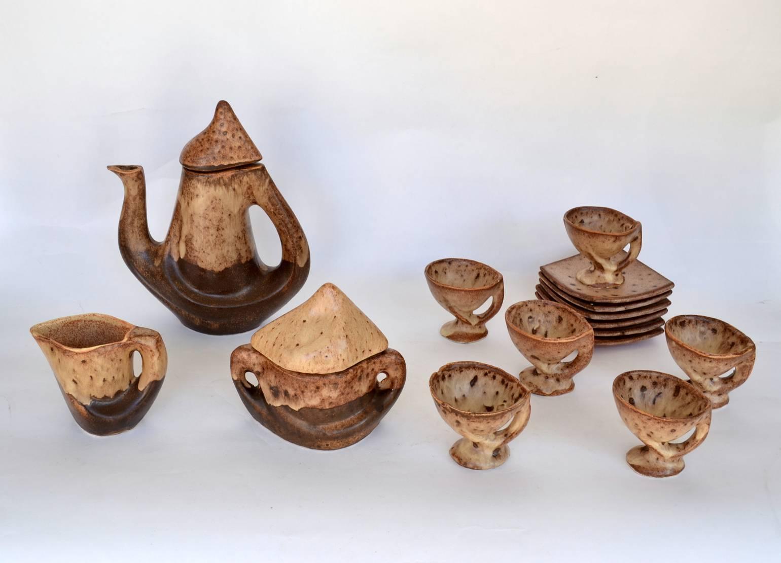 Organic studio pottery tea set for six servings, hand crafted and hand-painted in earth tones, by Vallauris France 1970s (French village on the Riviera where Picasso has worked.)

Six cups with plates (Cup: H. 8 cm x diameter 9 cm plate: 12.5 cm x