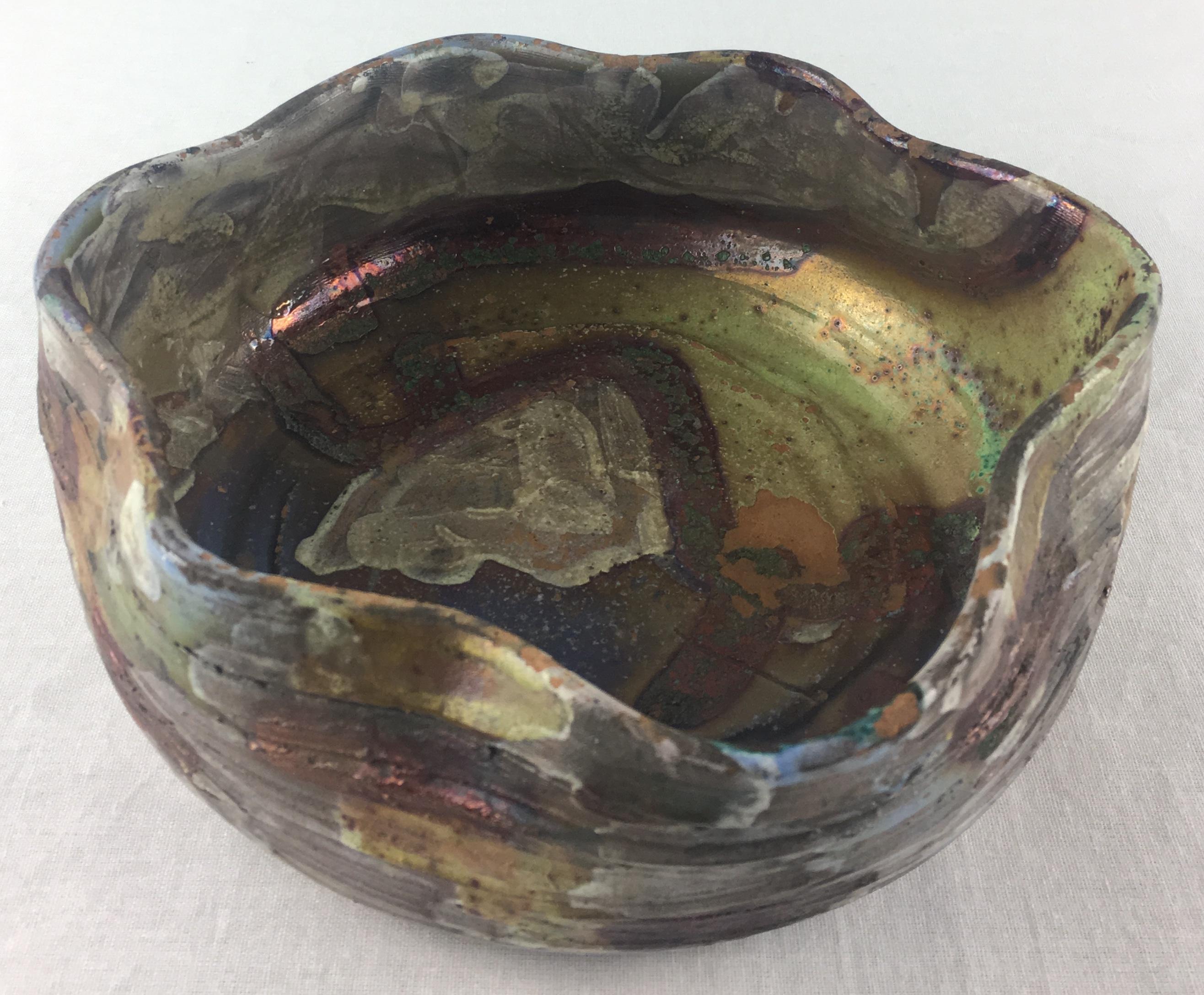 Beautiful mid-20th Century French metallic glaze bowl or vide poche possibly from Vallauris or Biot, France. The prominent colors in an art brut form make this metallic glaze bowl or vide poche particularly pleasing to the eye.

Would look great on
