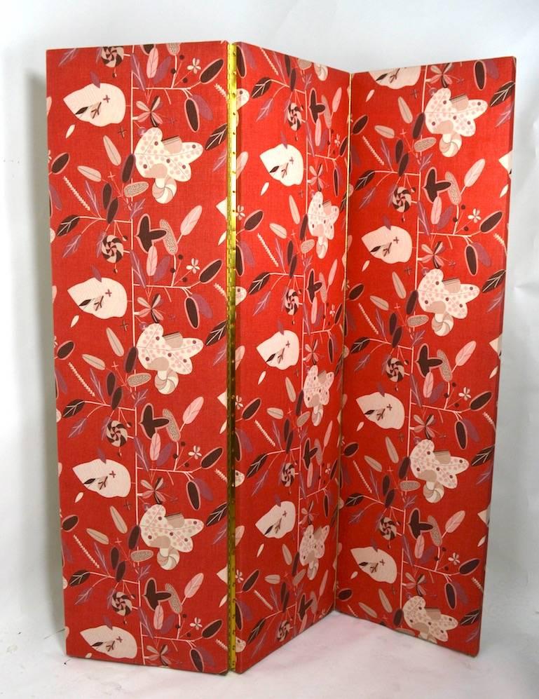 Upholstered front and back decorative folding dressing screen, room divider. Each panel has a floral pattern print on red ground (vintage linen Danish fabric ) with light cream back panel, also in fabric. Each panel is 20 inches W, constructed with