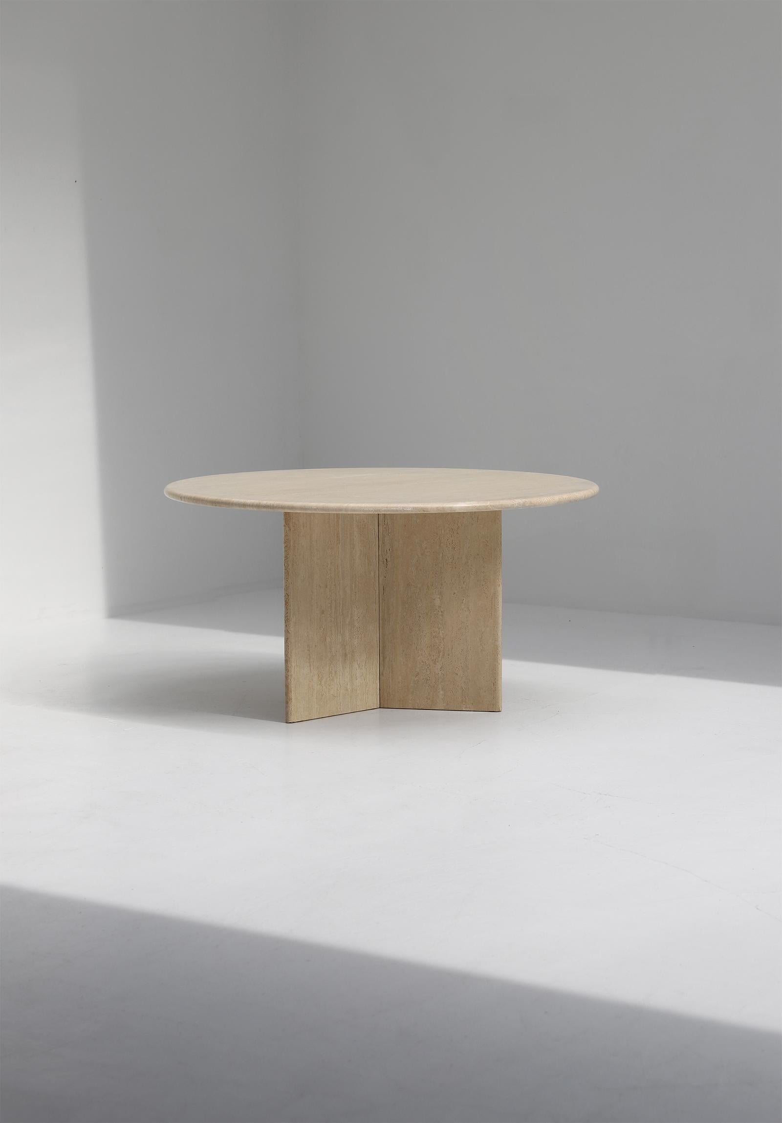 Decorative travertine dining table designed in the 1970s. The base is formed of three slabs of travertine, which combine into a triangle or star shape. The tabletop has a moon shaped pattern and makes it stand out. The table stands in a beautiful