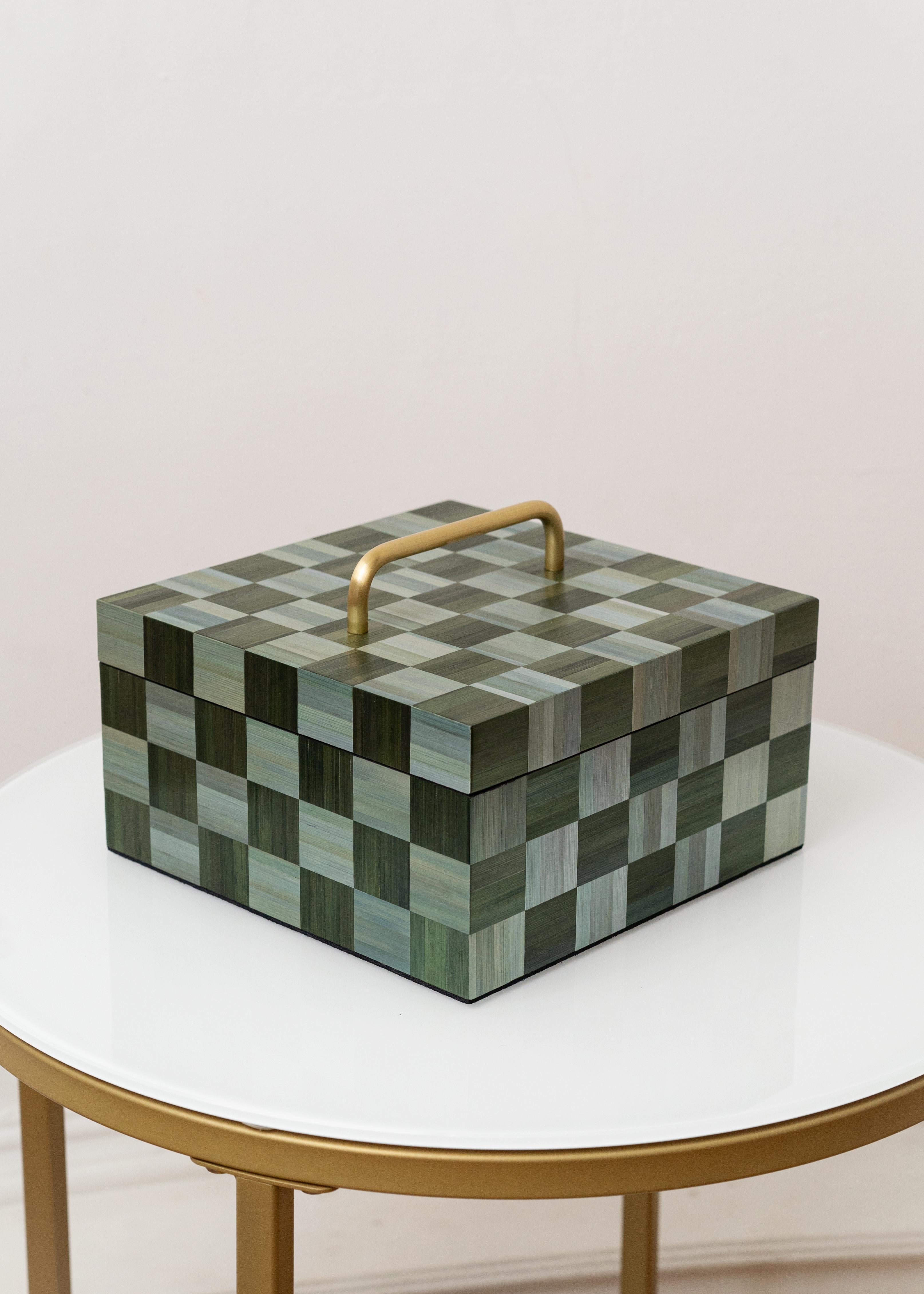 Straw Marquetry Decorative Box with Brass Handles Green Teal Inlay Checkerboard Pattern

Decorative Box 01 is a handcrafted square box created using the straw marquetry technique. Its surface features a checkerboard pattern composed of hand-dyed and