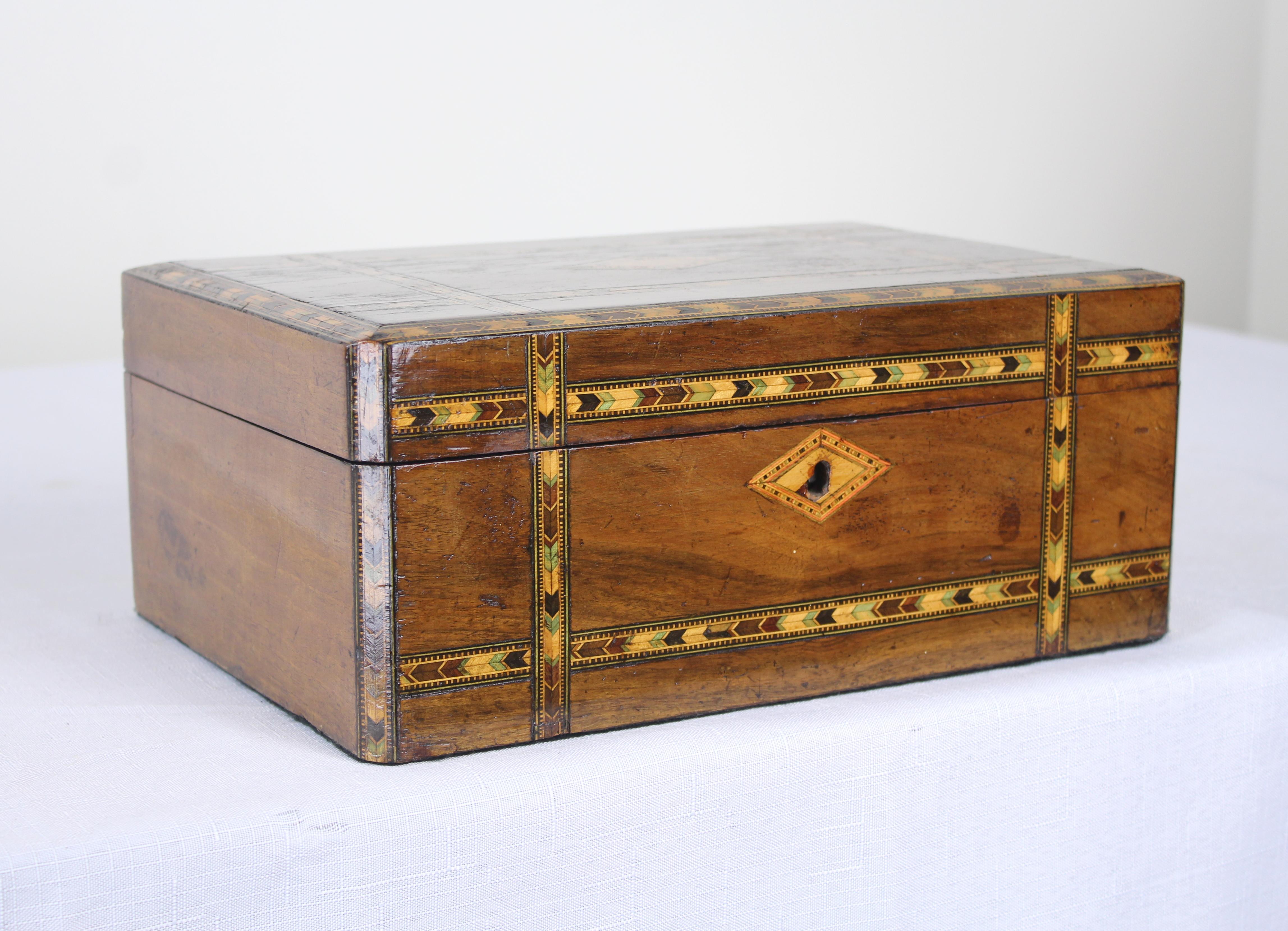 A decorative walnut Tumbridgeware box. Tumbridgeware being characterized as a form of decoratively inlaid woodwork, typically in the form of boxes, that is characteristic of Tumbridge and the spa town of Royal Tumbridge Wells in Kent in the 18th and