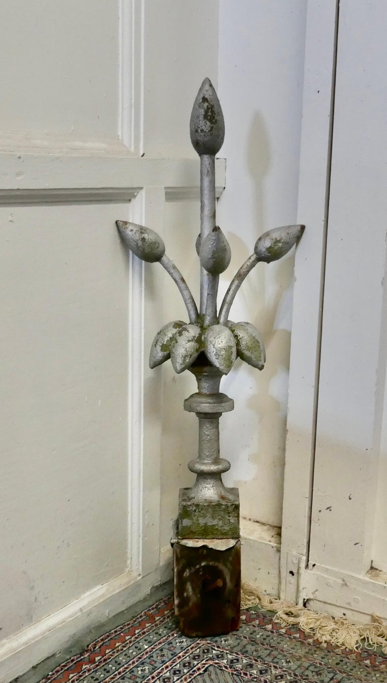 Decorative Victorian roof finial

A super decorative piece, the iron finial has a stylised flower design 
The piece is weather worn as you would expect but otherwise sound, and would make an excellent roof decoration
The finial is 34” tall, the