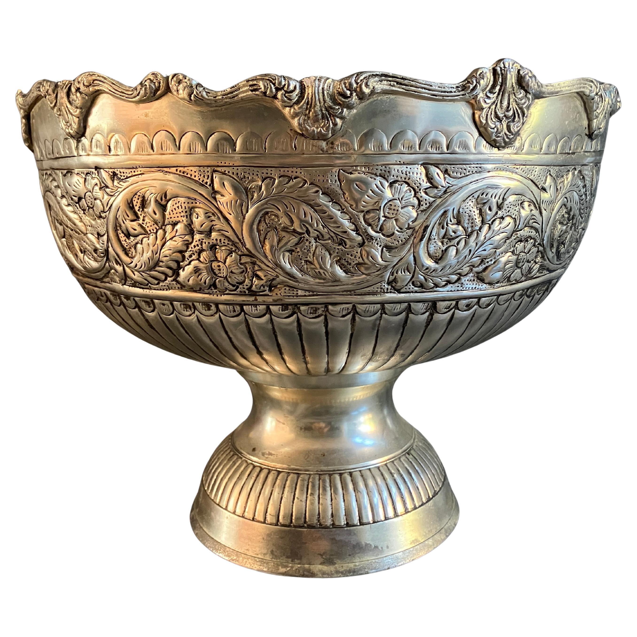 A stunning large Victorian punch bowl with a beautiful silver plated finish. The decoration runs all around the bowl and has a lovely flower chain motif. The bowl is huge and would also work as a gorgeous plant stand, or a centerpiece for a table,