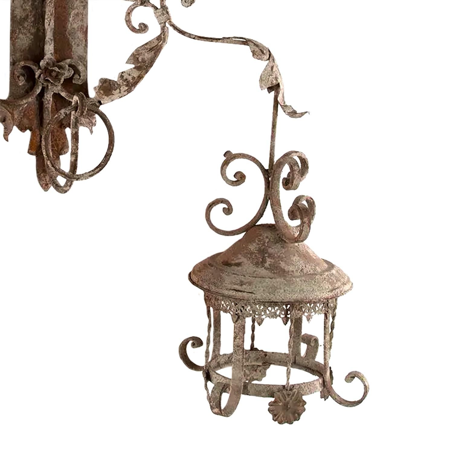 A decorative two-arm wall light from a vineyard in the south of France. This piece has a good time worn patina.