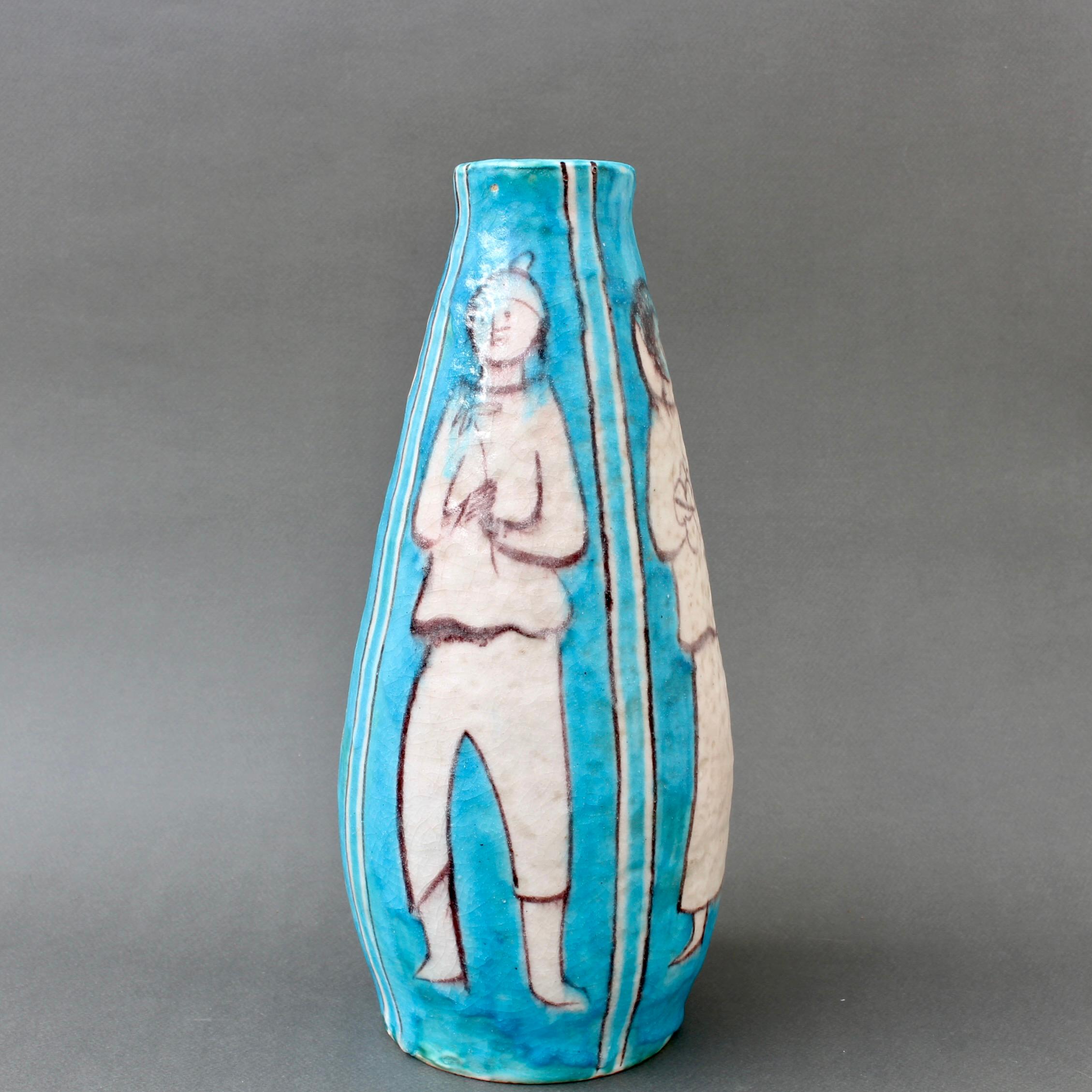 Vintage Blue ceramic vase by C.A.S. Vietri (circa 1950s). In the style of Guido Gambone, this stunning piece features decor of four people in various poses and activities in a chalk-white enamel with brown outlines separated by long, vertical