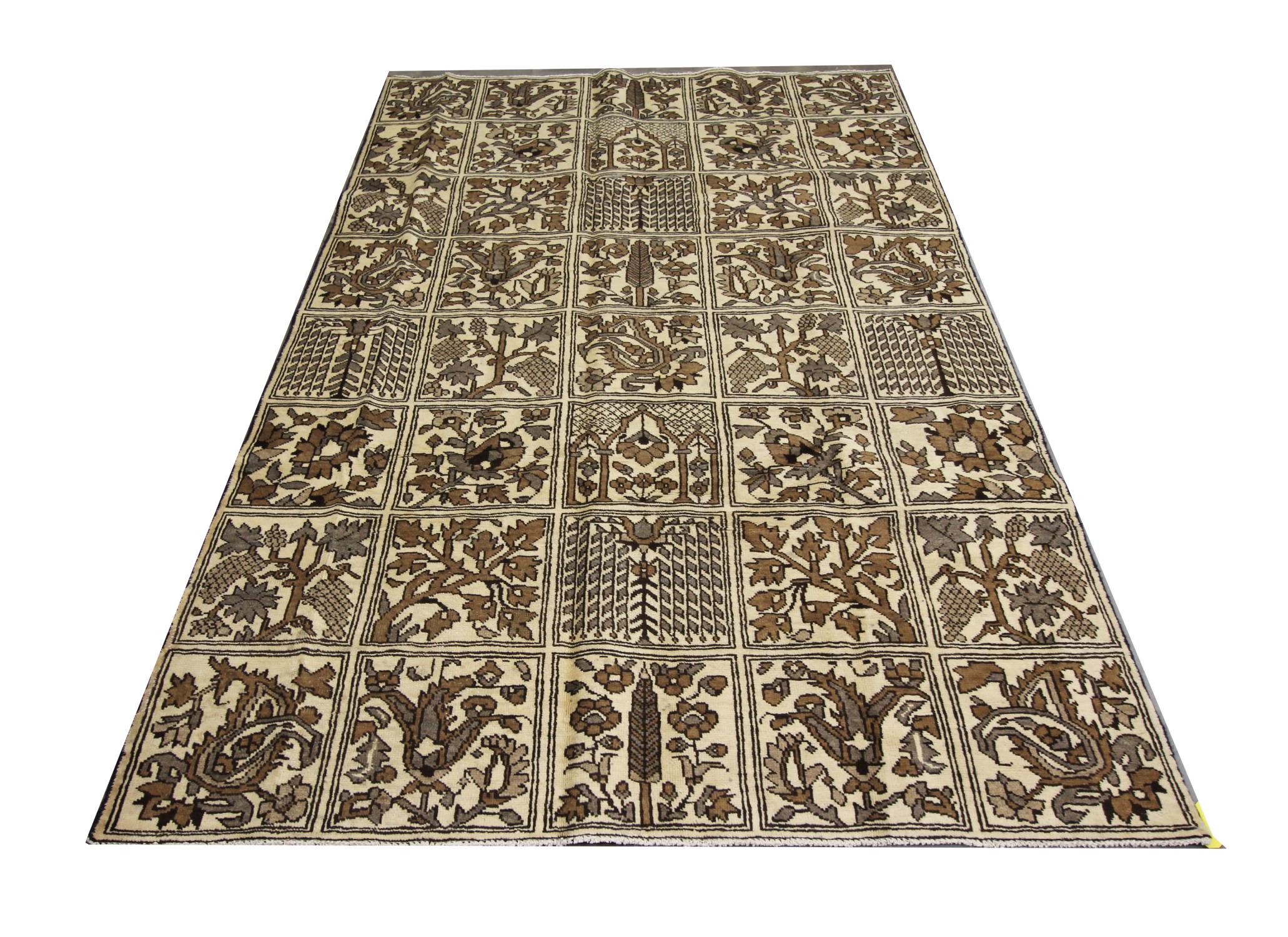 This large oriental carpet is a beautiful example of Turkish carpets woven in the early 20th century. The all-over design of this vintage rug has been woven on a rich beige field with oak brown, beige and accents that make up the decorative block of