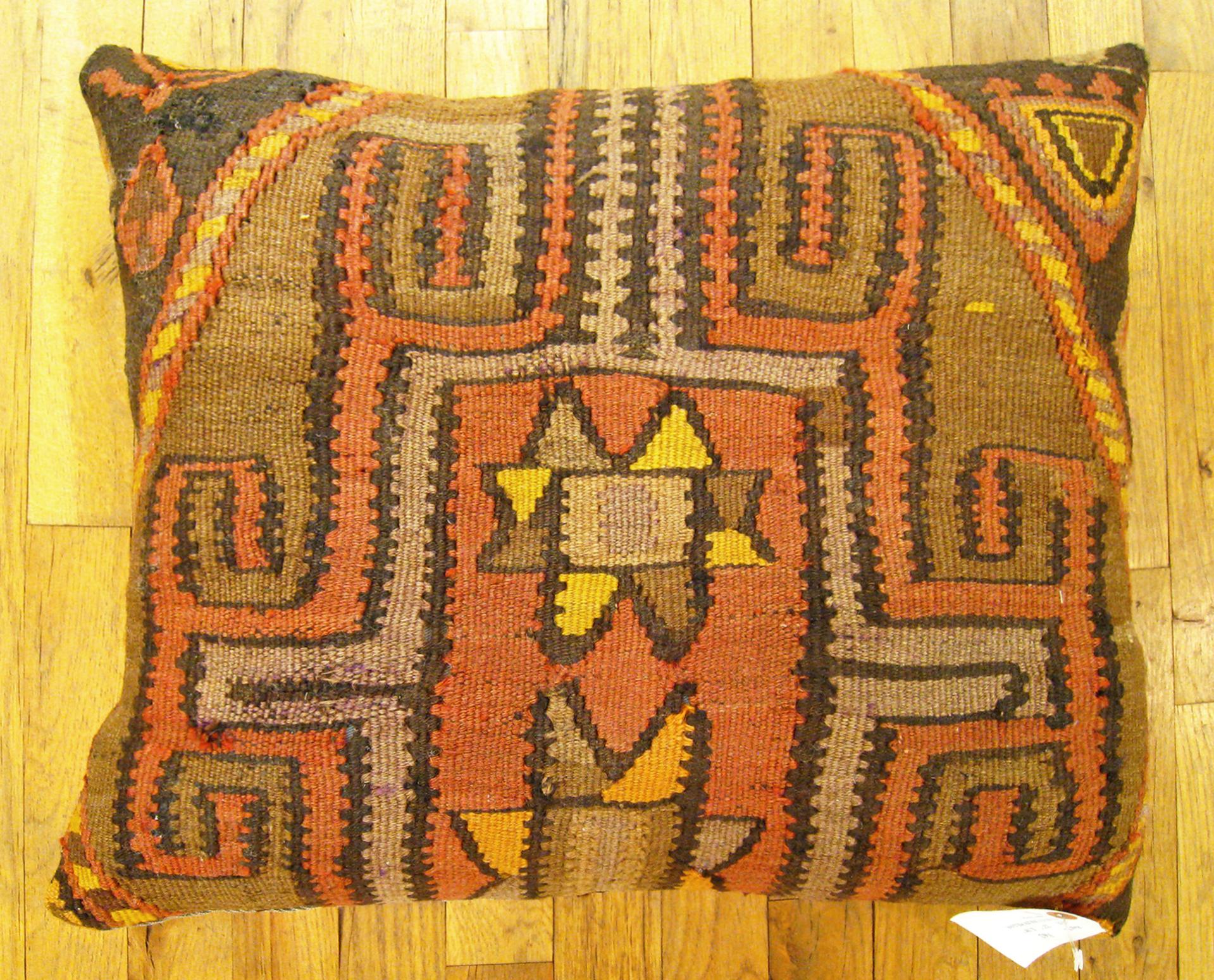 Vintage Turkish Kilim rug pillow; size 22” x 18”.

A vintage decorative pillow with geometric abstracts allover a brown central field, size 22” x 18”. This lovely decorative pillow features a vintage fabric of a KIilim carpet on front which is