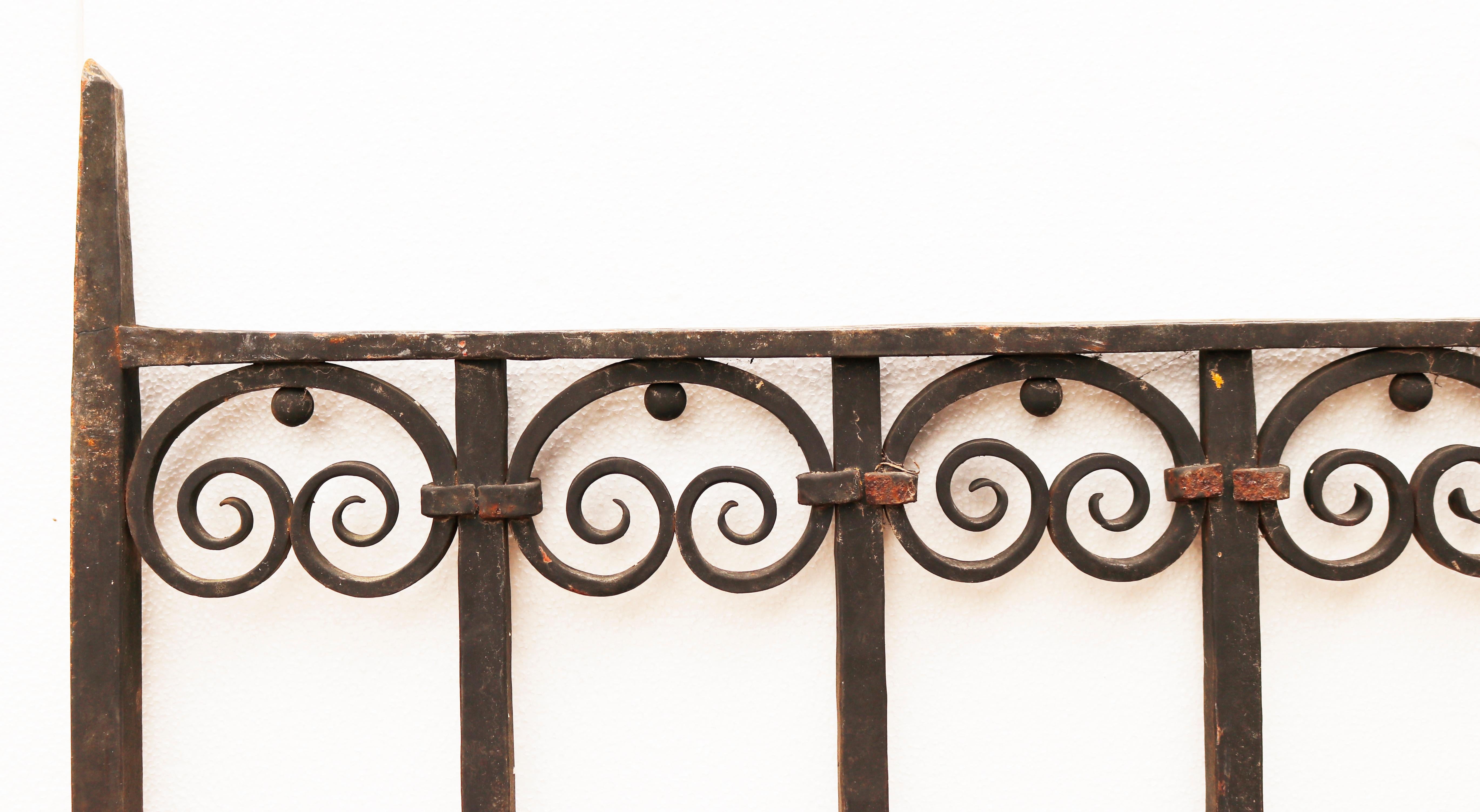Decorative Wrought Iron Garden Gate. A beautiful gate with detailed scrolls along the top, and flower motifs along the bottom.

What is Wrought Iron?

Wrought iron is a type of refined, low carbon iron that is smelted and worked on with tools. The