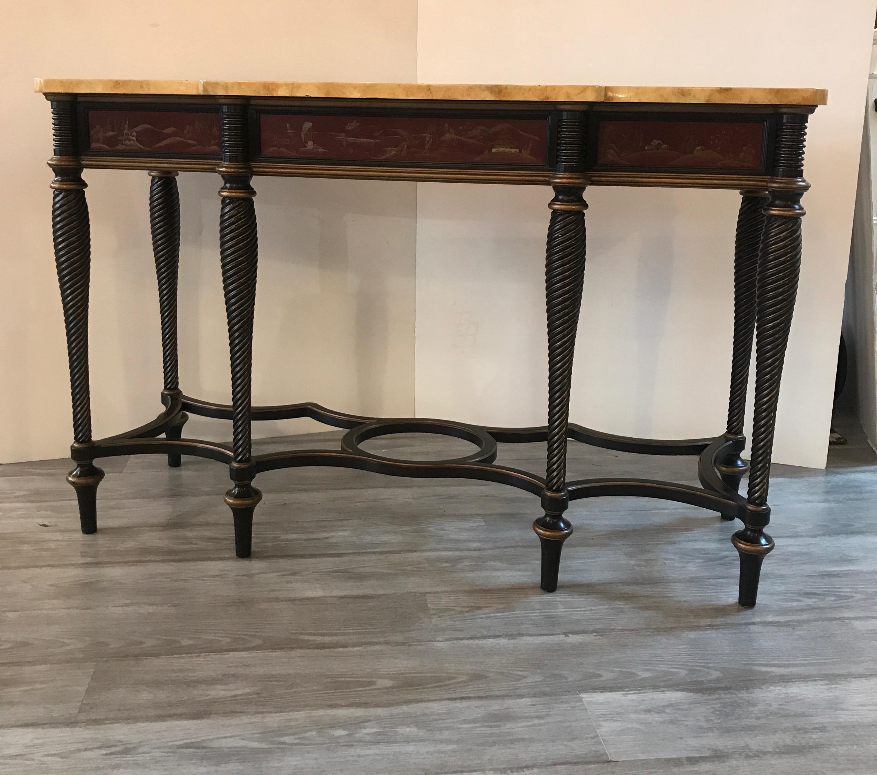 An hand painted and ebonized console table with front and side panels of painted chinoiserie decoration. The hand painted faux marble top, with black spiral legs with hand painted Chinese red front and side panels.