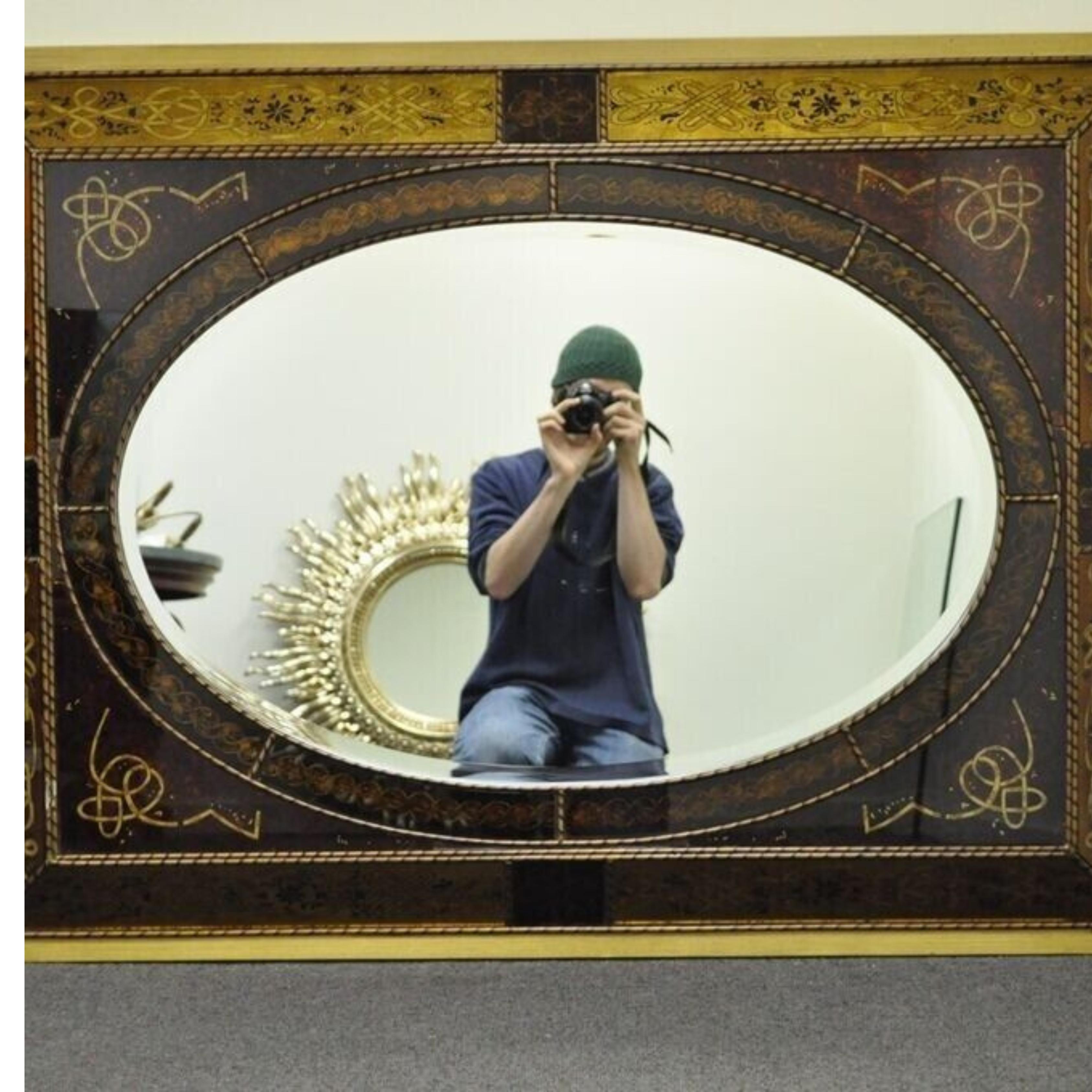 Decorator Italian Venetian Style Hollywood Regency Reverse Decorated Wall Mirror Item features a wood frame with beveled oval mirror, reverse decorated glass with scrolling knotwork and floral motifs, can hang vertically or horizontally. 21st