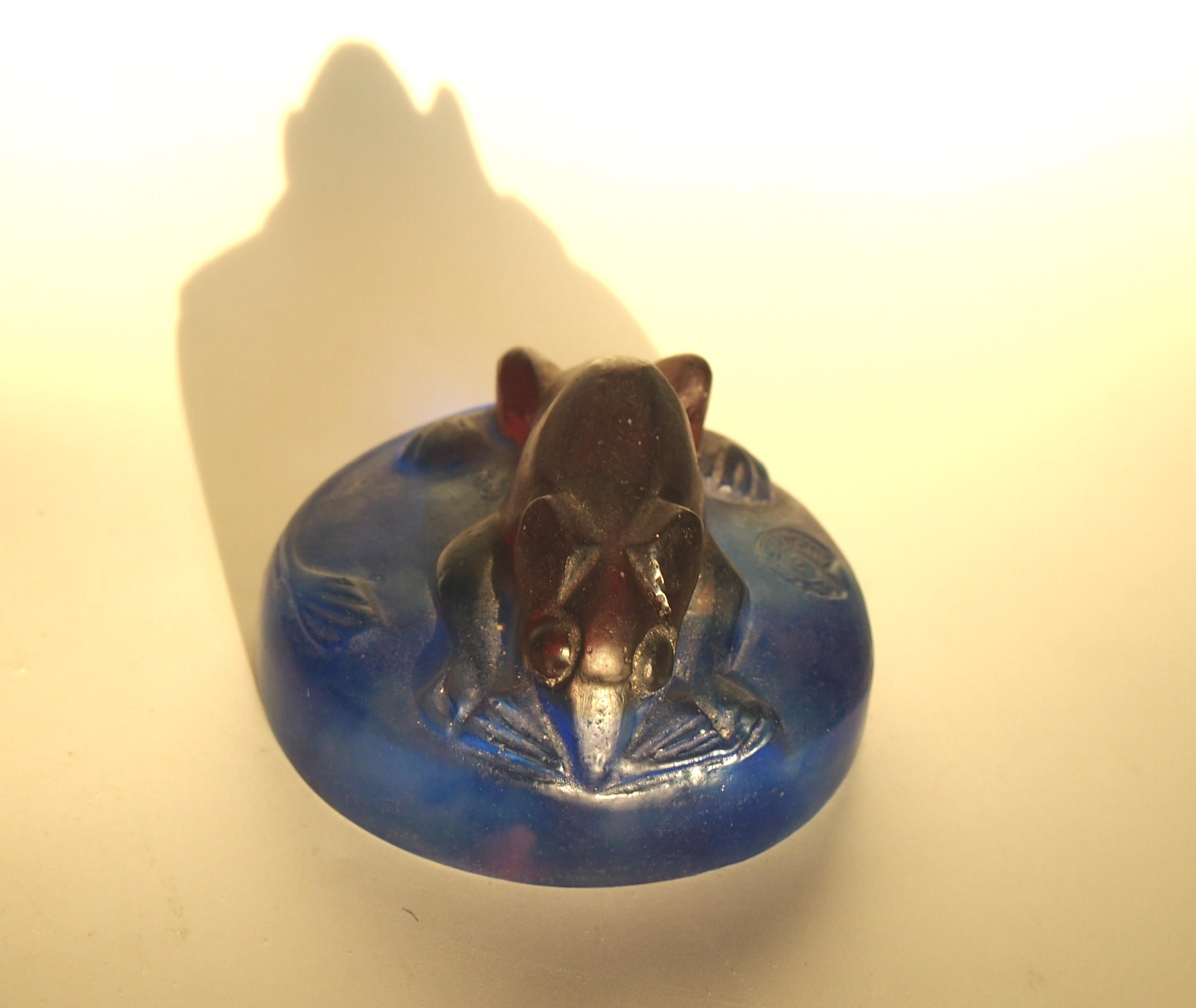A Francois-Emile Decorchement (1880-1970) late Art Deco Pâtes de Crystal 'Loir' Paperweight. Designed 1952, Molded as a dormouse, in browns and blues signed with a molded 'Decorchement' in a circular Cartouche see image 3.
 
This was one of his