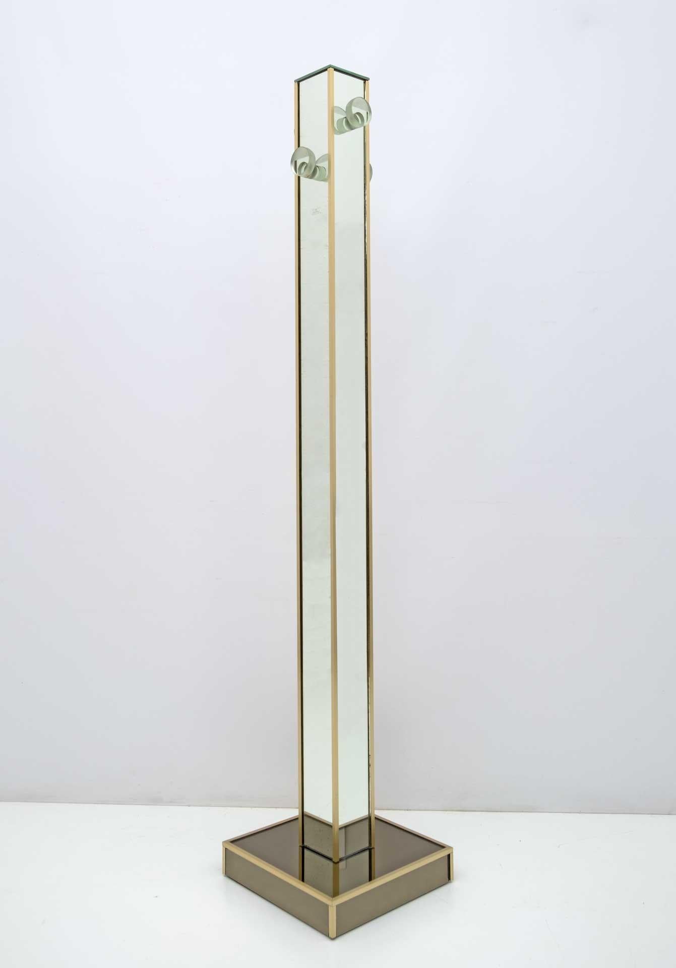 Mirror coat stand produced by the well-known Italian company Decovetro, production in the 70s. Composed of four thick glass hangers, classic mirrors on the facades and smoked mirrors, with brass finish on the edges.