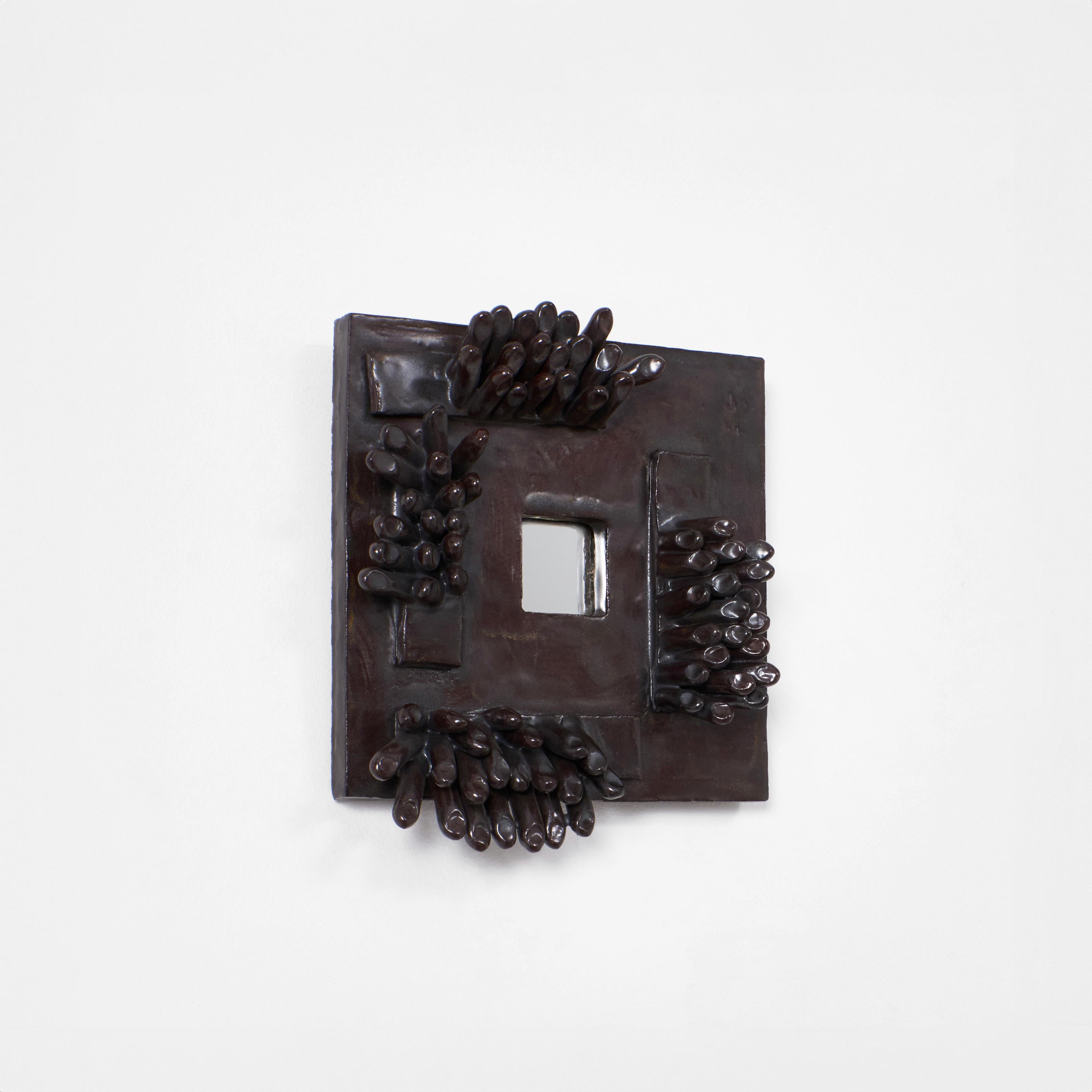 DEDO MIRROR No1, designed in 2025. 

Artisanal ceramic mirror is crafted by skilled artisans in Project 213A's own ceramic workshop. The frame is decorated with  sculptural finger ornaments.
Each piece is unique due to its handmade nature, shapes