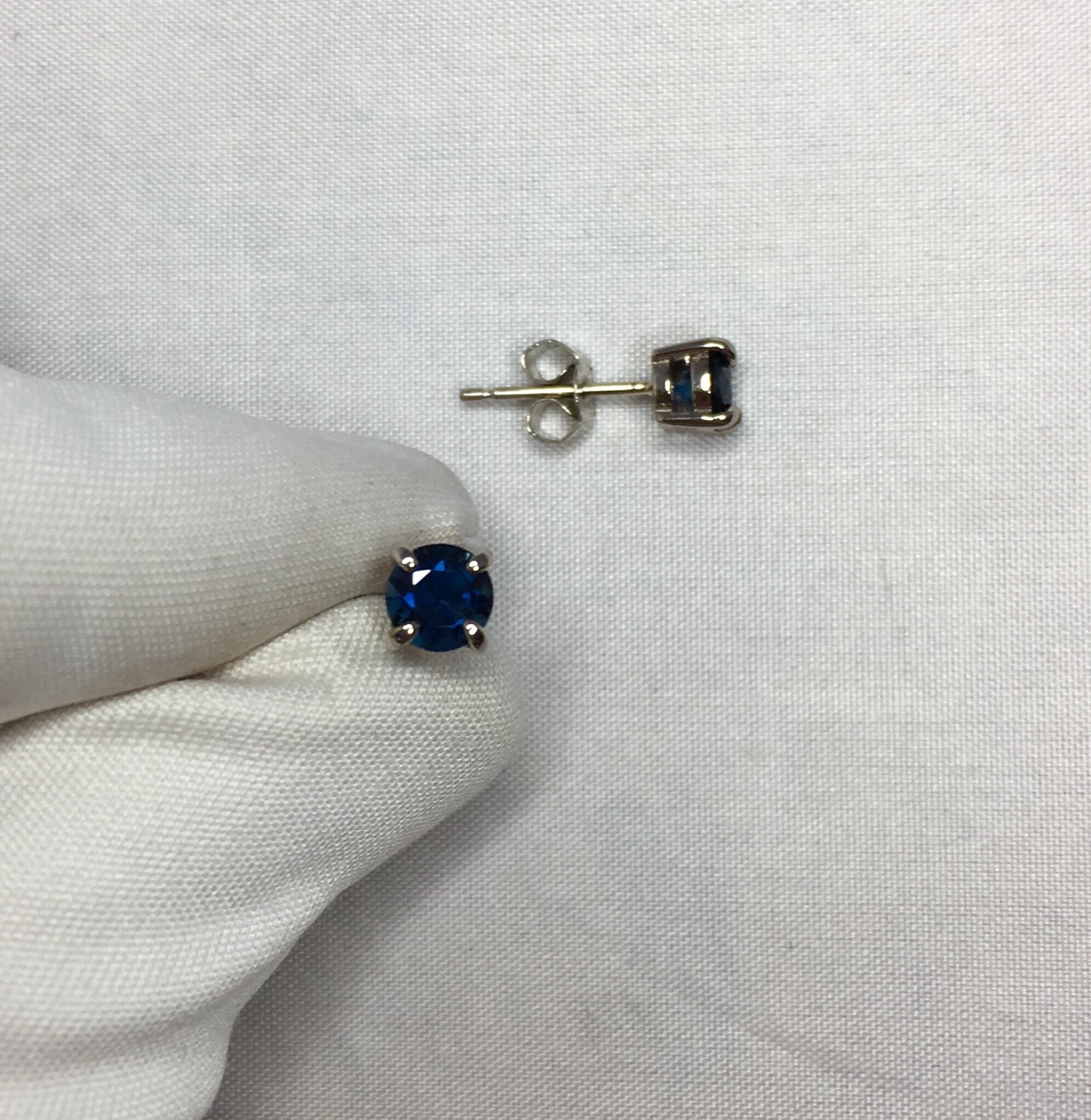 Stunning natural 5mm deep blue Australian Sapphire earring studs in 18k white gold.

1.22 carat matching pair.

Both have a beautiful deep blue colour and excellent clarity.
They also have an excellent round cut and look stunning when the light