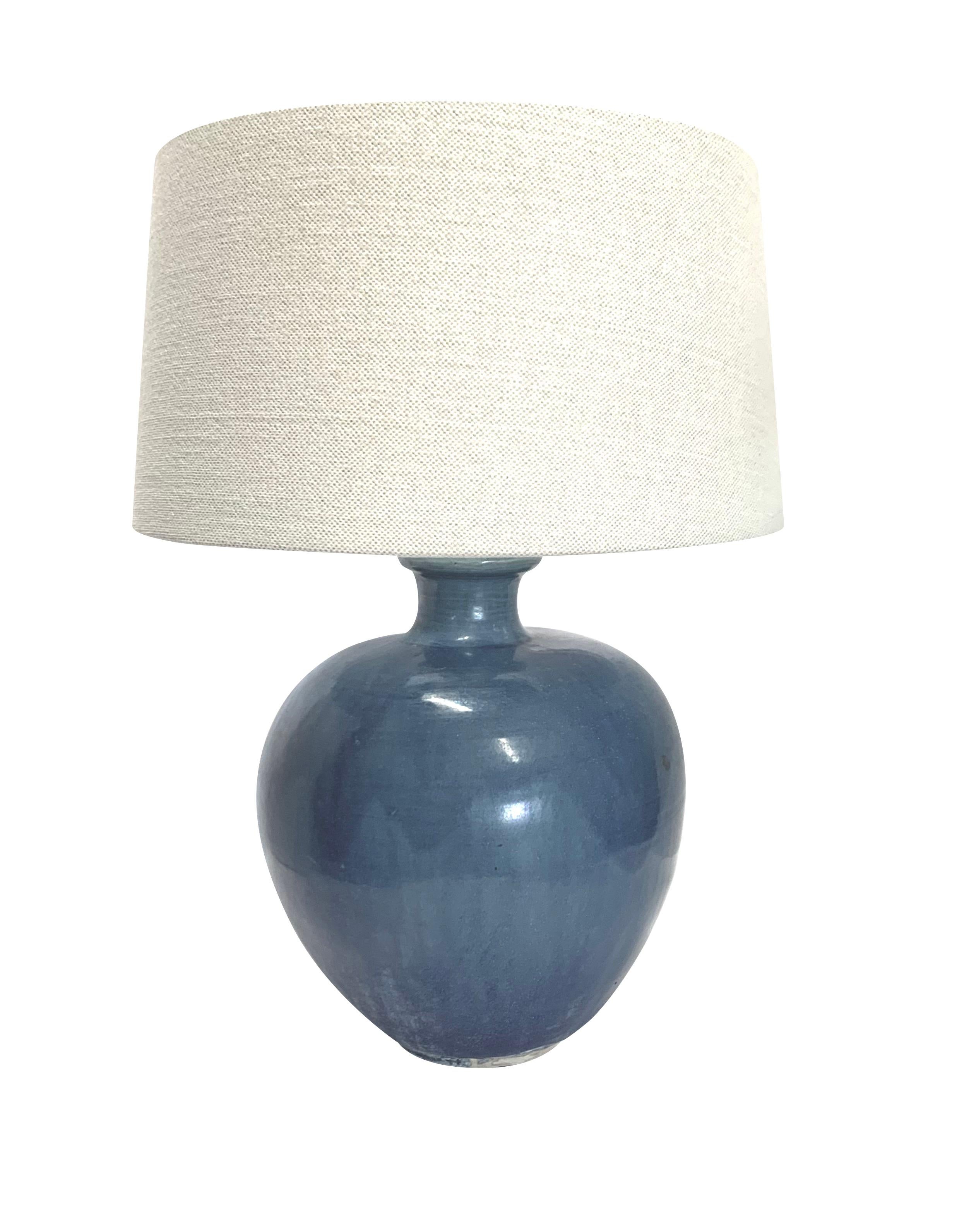 Contemporary Chinese pair deep blue glazed lamps.
Thin spout top with rounded base.
Also available as vases S5752
Belgian linen shades
Base measures 9
