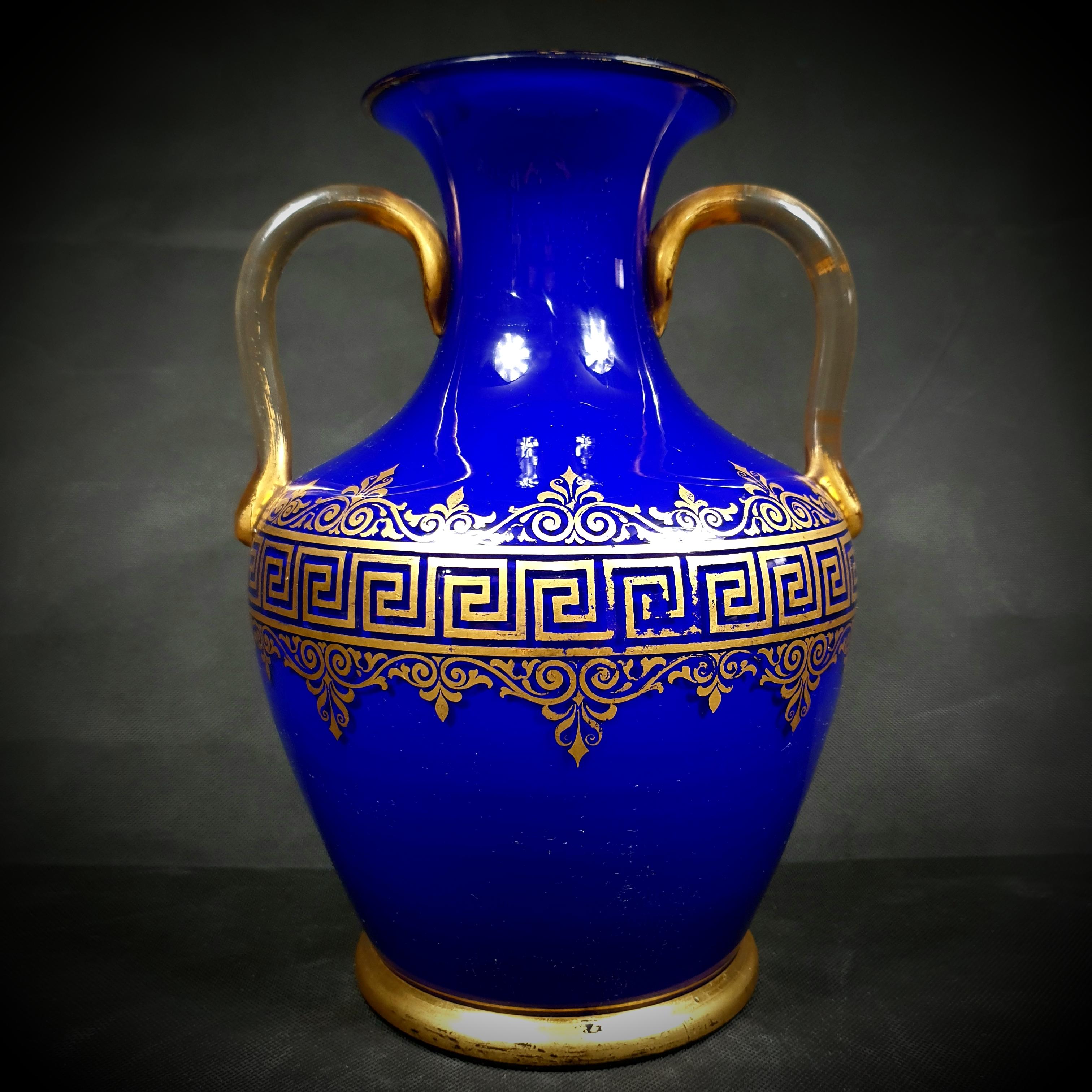 Looking for a timeless piece to elevate your home décor? Look no further than this exquisite antique opaline glass vase, a stunning addition to any room. Made in France between 1850 and 1920, this deep blue spherical vase boasts intricate geometric