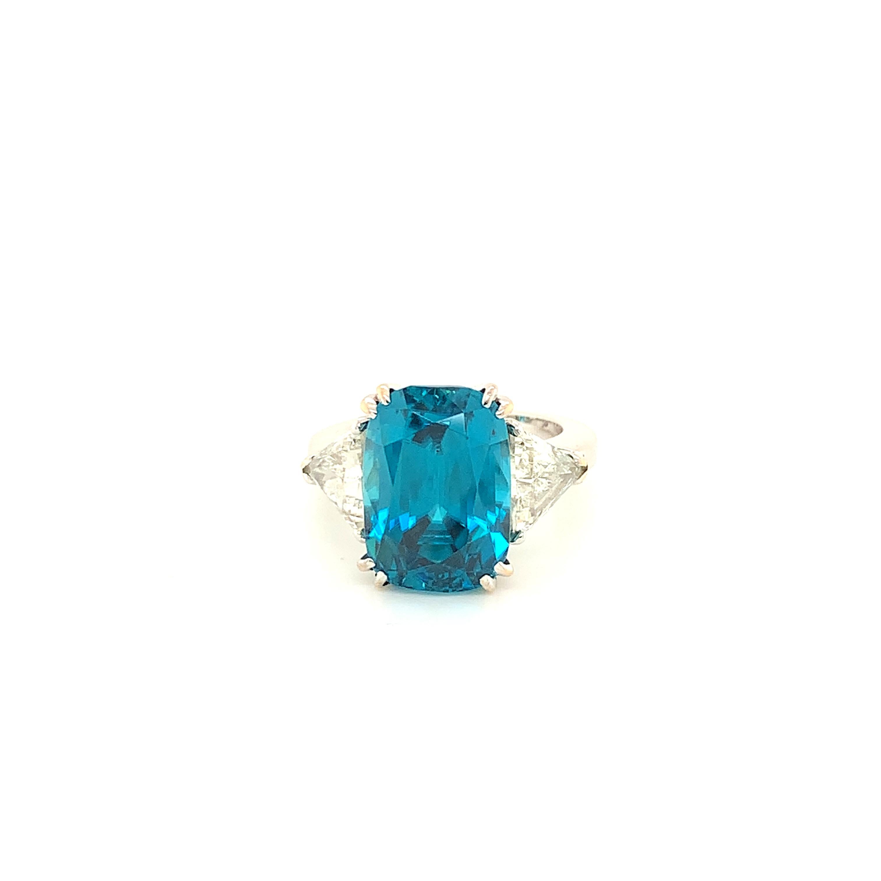 18K Gold Deep Blue zircon  16,61 Cts Ring with diamonds 1,50 Cts 
Deep blue ring set with a top blue zircon cushion cut 16.61 Cts, two diamonds side stones 
approx. 1,50 Cts .
Zircon is a beautiful, natural gemstone with a high refractive index and